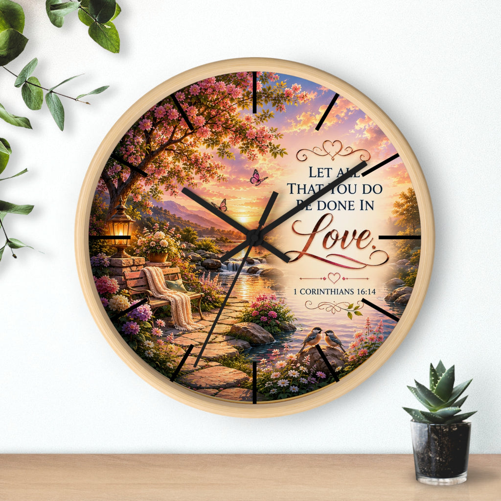 Inspirational Christian wall clock featuring a flower-lined lakeside sunrise scene with 1 Corinthians 16:14 scripture about doing all things in love.