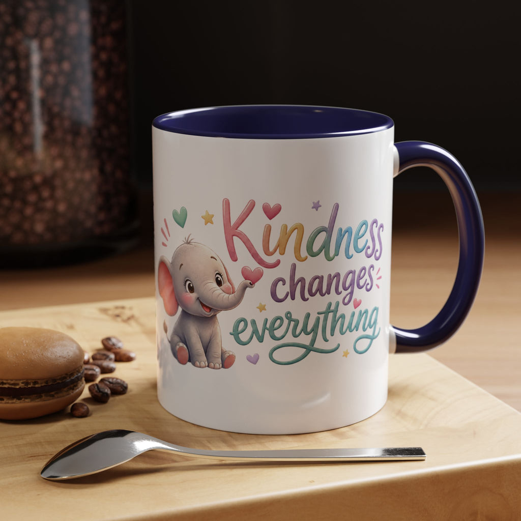 Cute ceramic coffee mug featuring a pastel baby elephant and the uplifting message “Kindness Changes Everything” with colorful accent handle and interior.