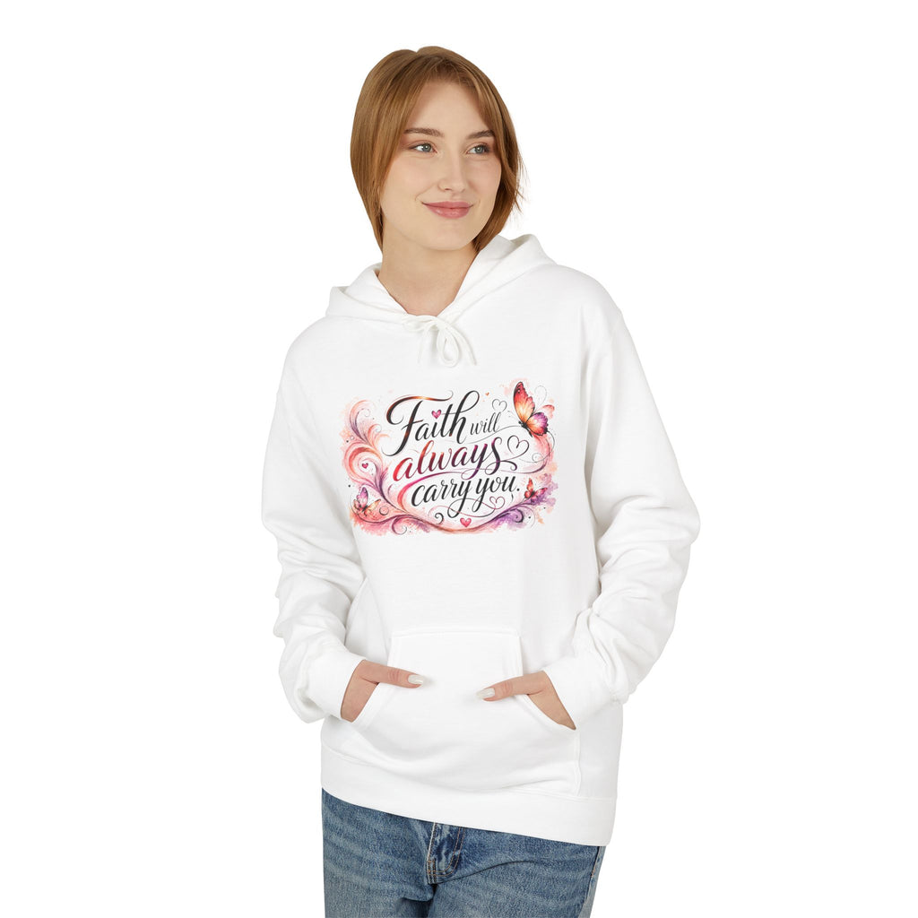 A woman wearing a white pullover hoodie with a colorful graphic on the chest that reads 'Faith will always carry you' in black script with pink, purple, and orange floral accents. She is also wearing blue jeans, set against a plain white background.