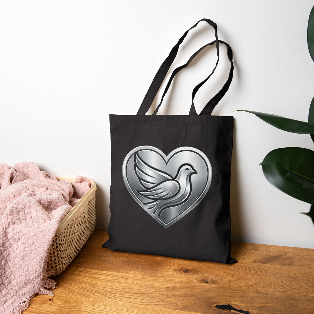 Cotton canvas tote bag featuring a silver dove inside a heart design, symbolizing peace, love, faith, hope, and encouragement in an elegant minimalist style.