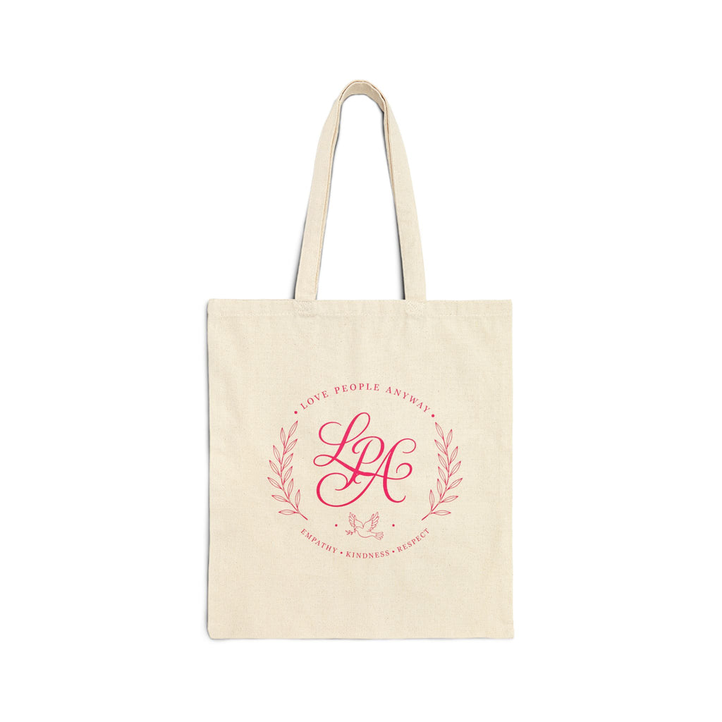 Pink monogram cotton canvas tote bag featuring the message “Love People Anyway,” laurel branches, a dove carrying an olive branch, and the words empathy, kindness, and respect in an elegant boutique design.