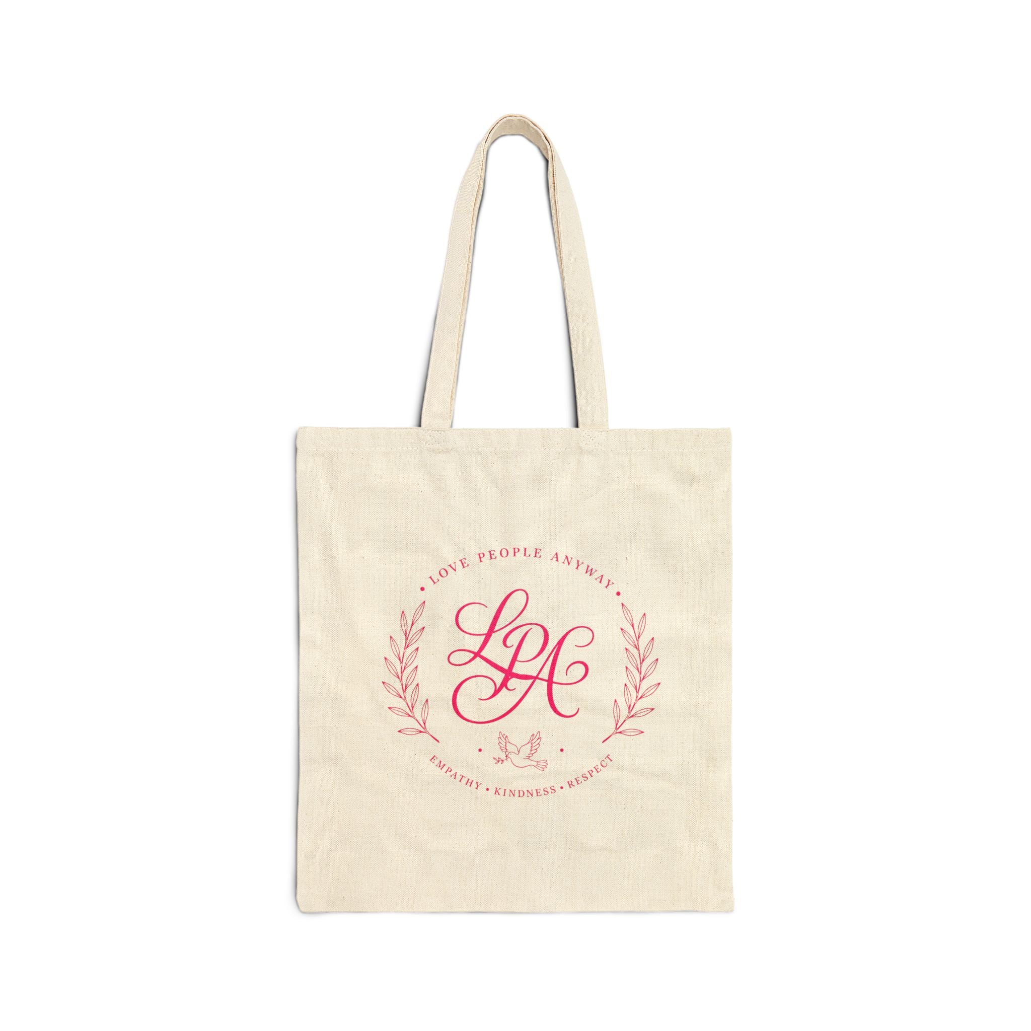 Pink monogram cotton canvas tote bag featuring the message “Love People Anyway,” laurel branches, a dove carrying an olive branch, and the words empathy, kindness, and respect in an elegant boutique design.