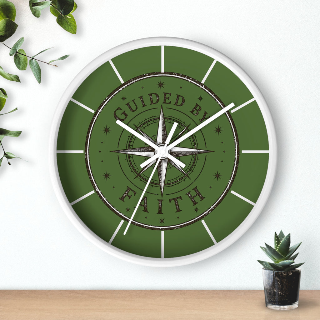 Rustic inspirational wall clock featuring a vintage compass design and the words “Guided by Faith” on an olive-green distressed background with silent movement.