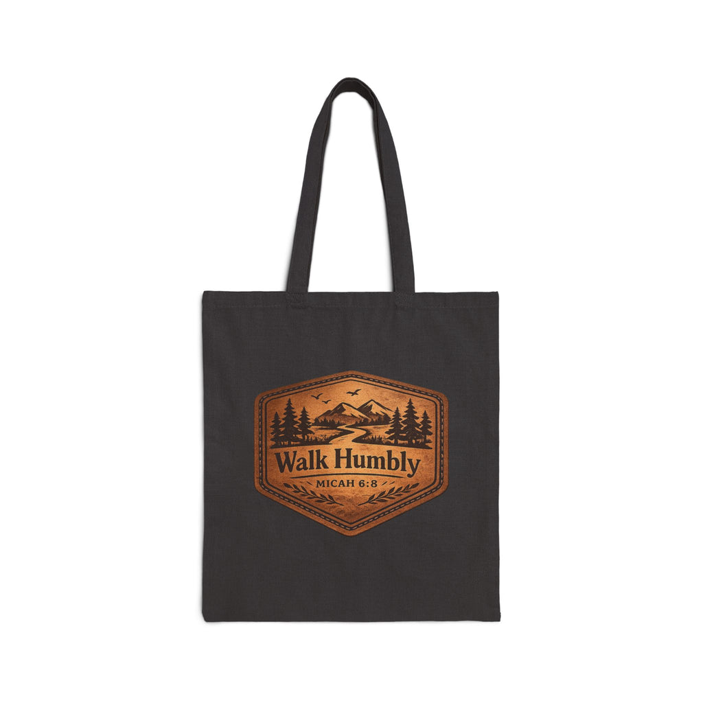 Rustic Christian cotton canvas tote bag featuring Micah 6:8 and the message “Walk Humbly,” with vintage mountain landscape artwork, pine trees, birds, and a winding trail in a leather-patch style design.