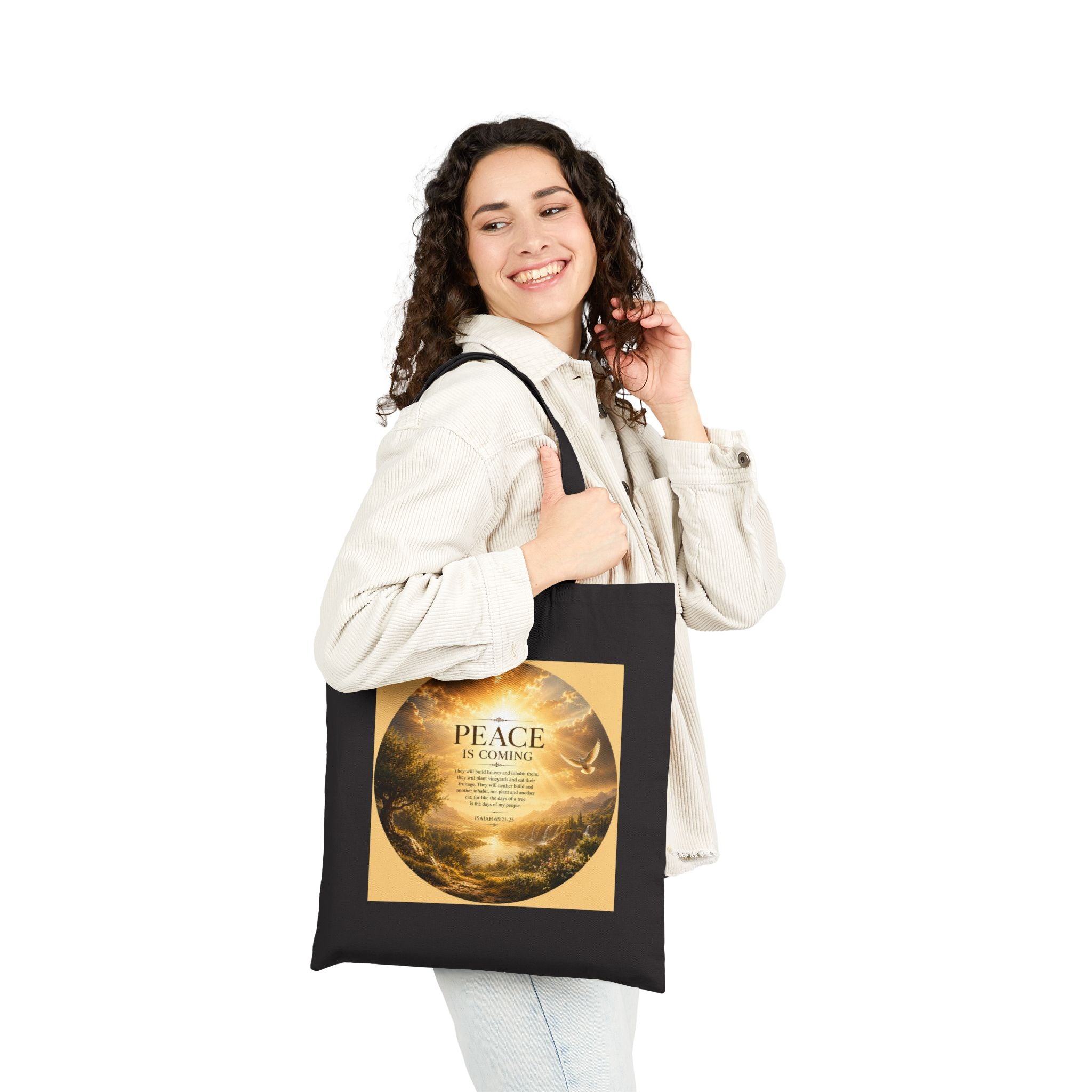 Christian cotton canvas tote bag featuring Isaiah 65:21-25 and the message “Peace Is Coming,” with golden paradise landscape artwork, waterfalls, mountains, river, white dove, and radiant sunlight.