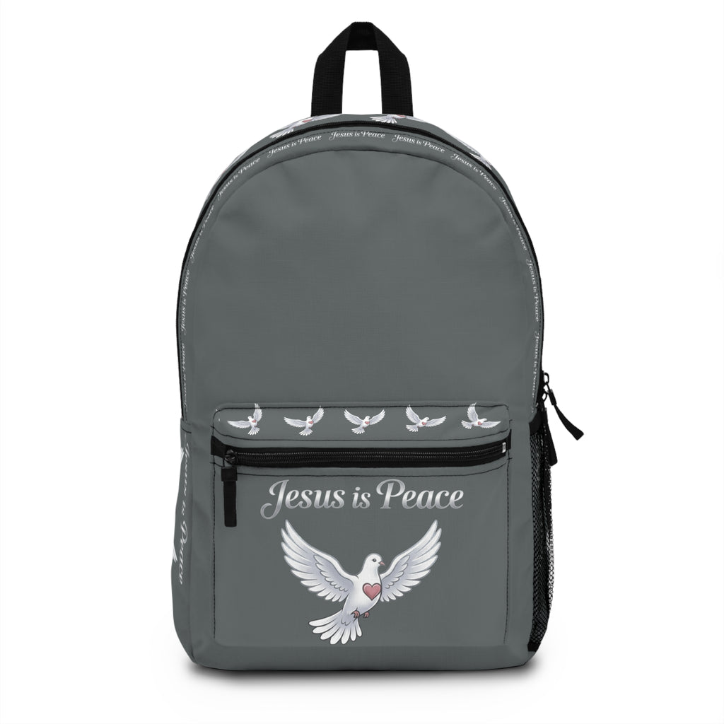 Gray Christian backpack featuring a white dove carrying a heart beneath the words "Jesus Is Peace," with multiple zippered compartments and padded shoulder straps.