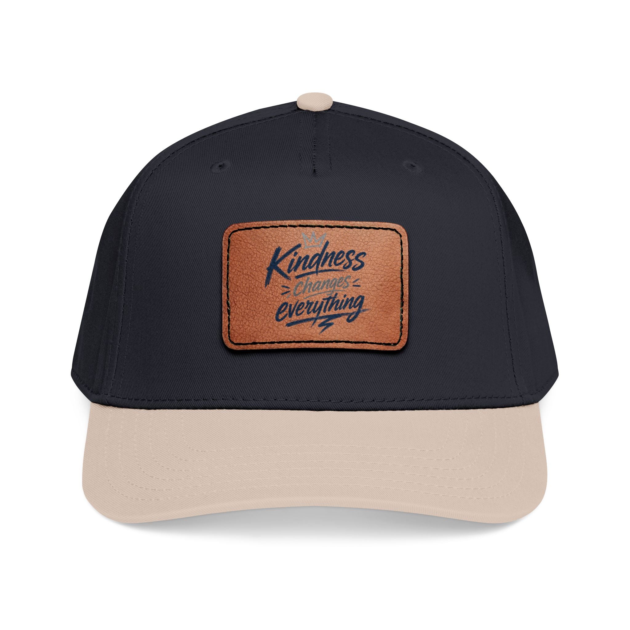 Vintage-inspired baseball cap featuring a brown leather patch with the phrase “Kindness Changes Everything” on a structured mid-profile snapback hat.