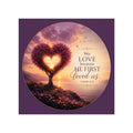 Christian vinyl sticker featuring a heart-shaped flowering tree at sunset overlooking a shoreline with the scripture “We Love Because He First Loved Us” from 1 John 4:19 in elegant lettering.