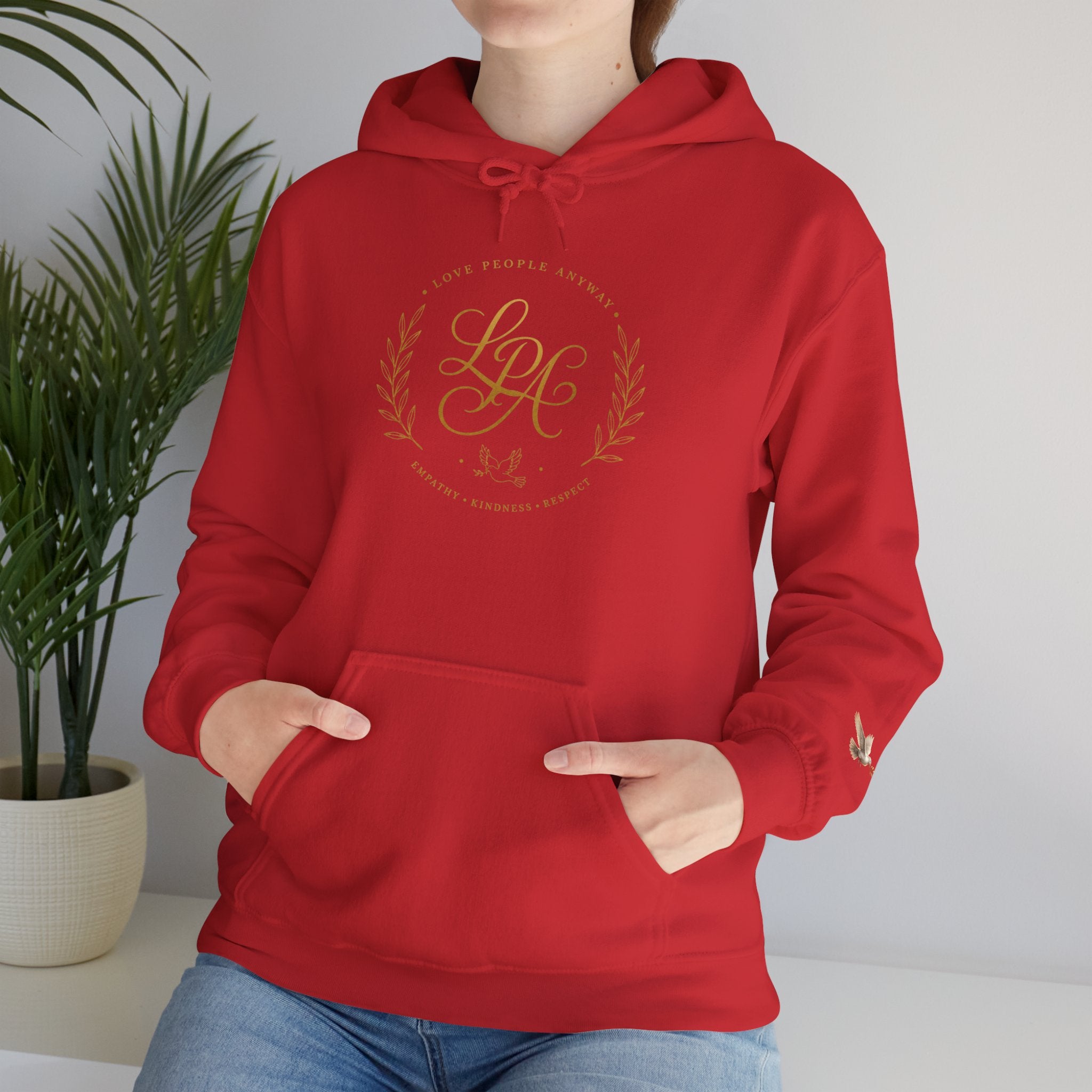 Inspirational Christian hoodie featuring elegant “Love People Anyway” script typography on a soft, cozy hooded sweatshirt designed to encourage kindness and compassion.