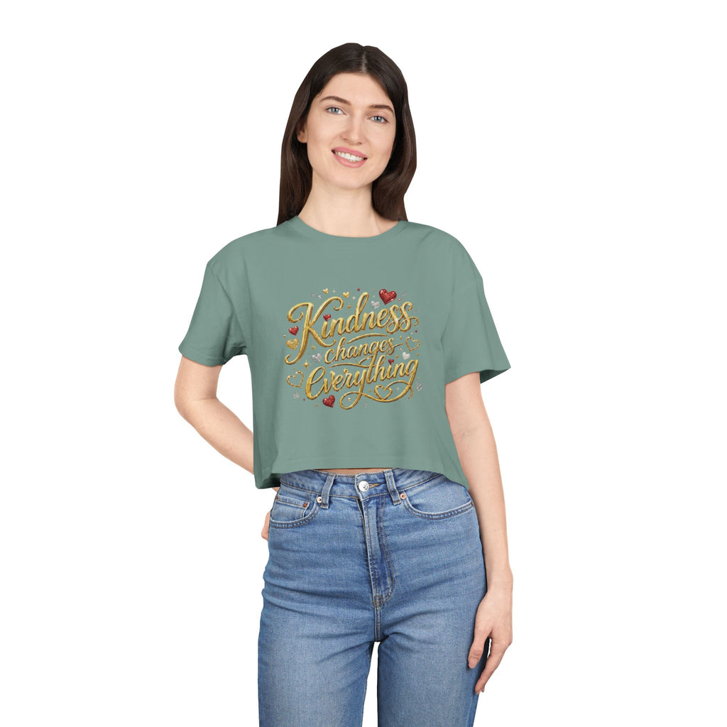 Women’s cropped inspirational t-shirt featuring the phrase “Kindness Changes Everything” in warm hand-lettered design with a relaxed casual fit.