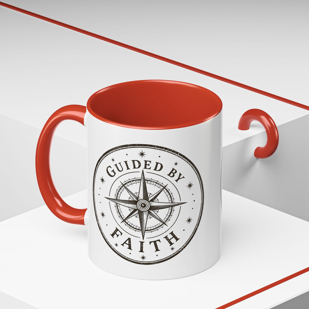 Inspirational ceramic accent coffee mug featuring a compass design and “Guided by Faith” message with colorful handle and interior accents on a glossy white mug.