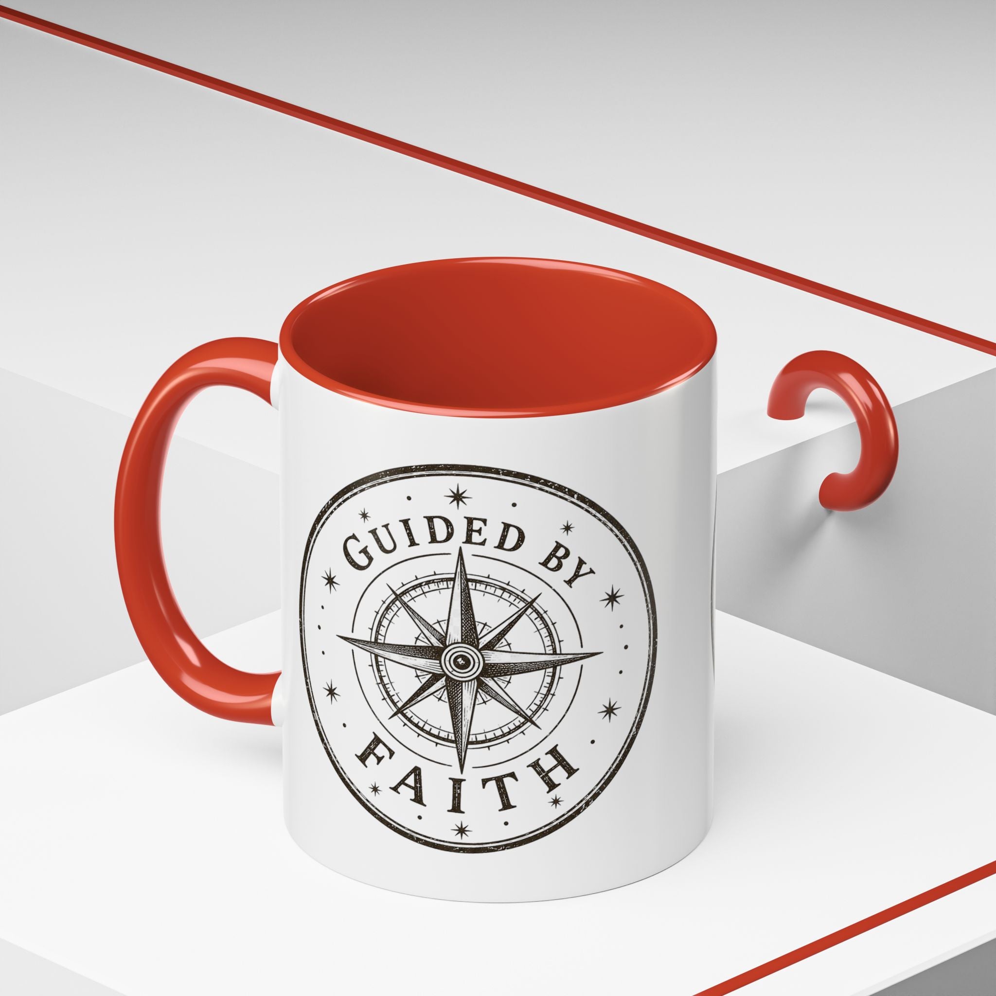 Inspirational ceramic accent coffee mug featuring a compass design and “Guided by Faith” message with colorful handle and interior accents on a glossy white mug.