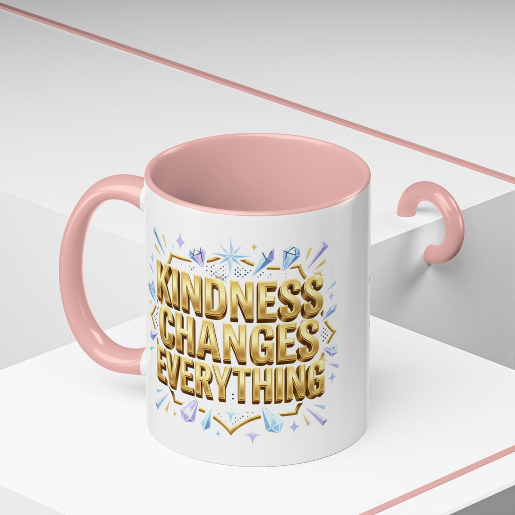 Inspirational ceramic accent coffee mug featuring “Kindness Changes Everything” in elegant gold script with sparkles and colorful accent handle and interior.