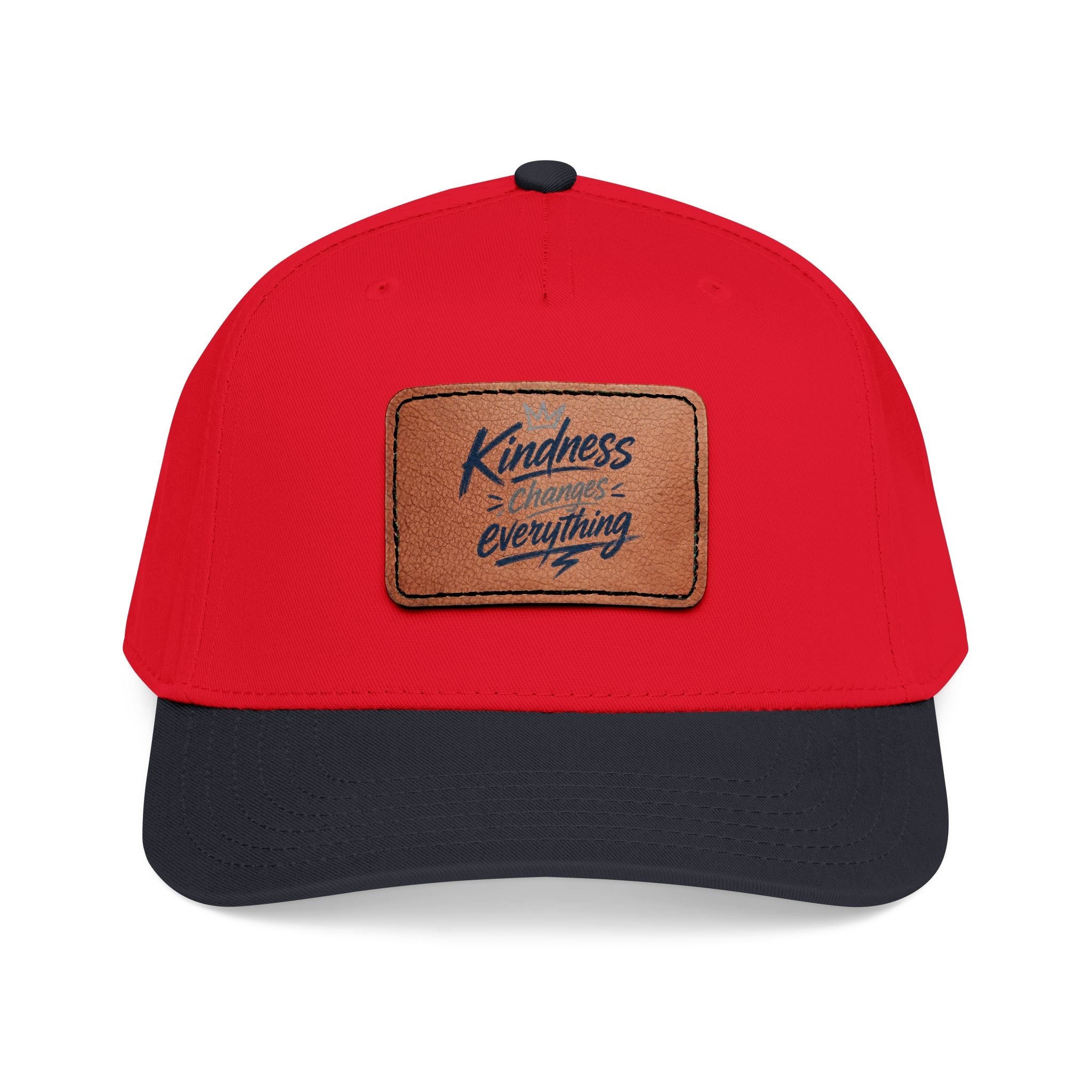 Vintage-inspired baseball cap featuring a brown leather patch with the phrase “Kindness Changes Everything” on a structured mid-profile snapback hat.