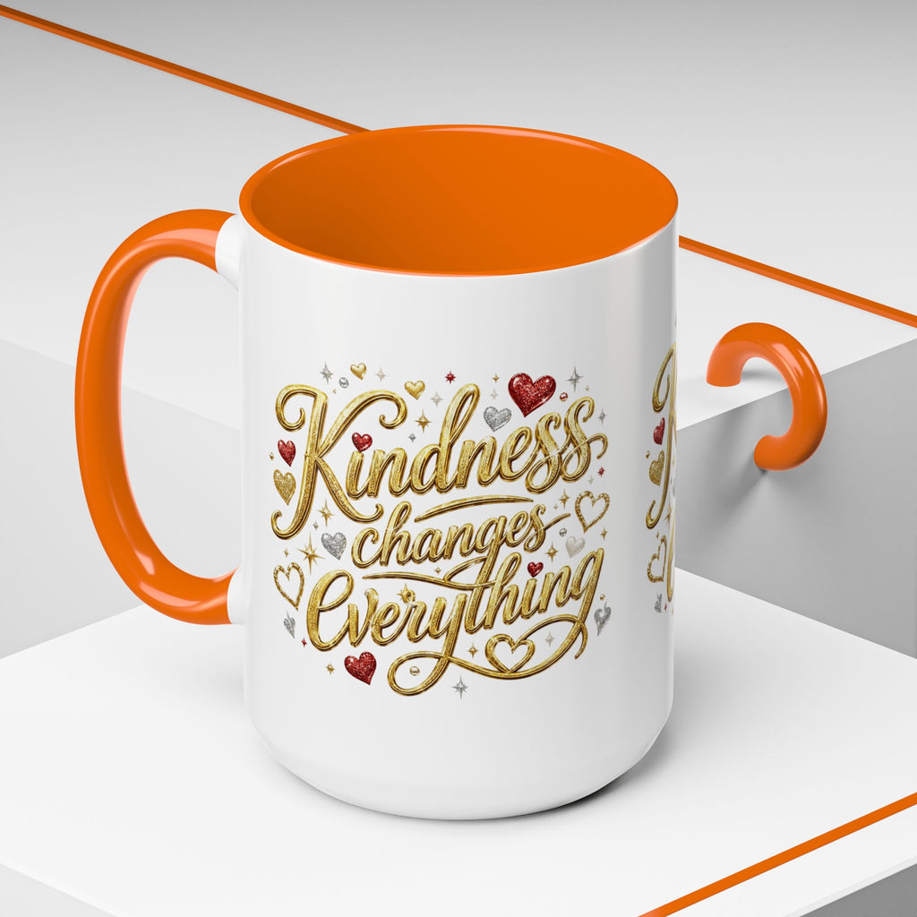 Inspirational ceramic coffee mug featuring the hand-lettered message “Kindness Changes Everything” with gold flourishes, hearts, and colorful accent handle and interior.