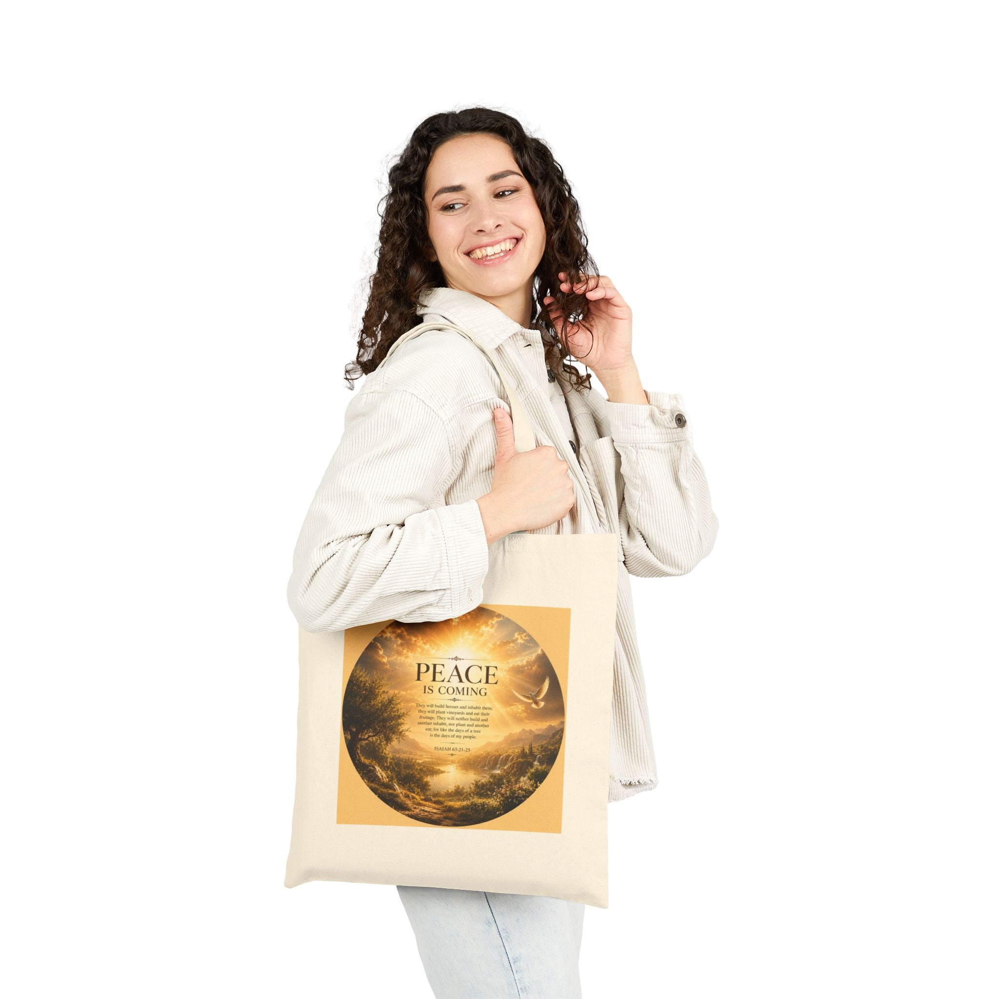 Christian cotton canvas tote bag featuring Isaiah 65:21-25 and the message “Peace Is Coming,” with golden paradise landscape artwork, waterfalls, mountains, river, white dove, and radiant sunlight.