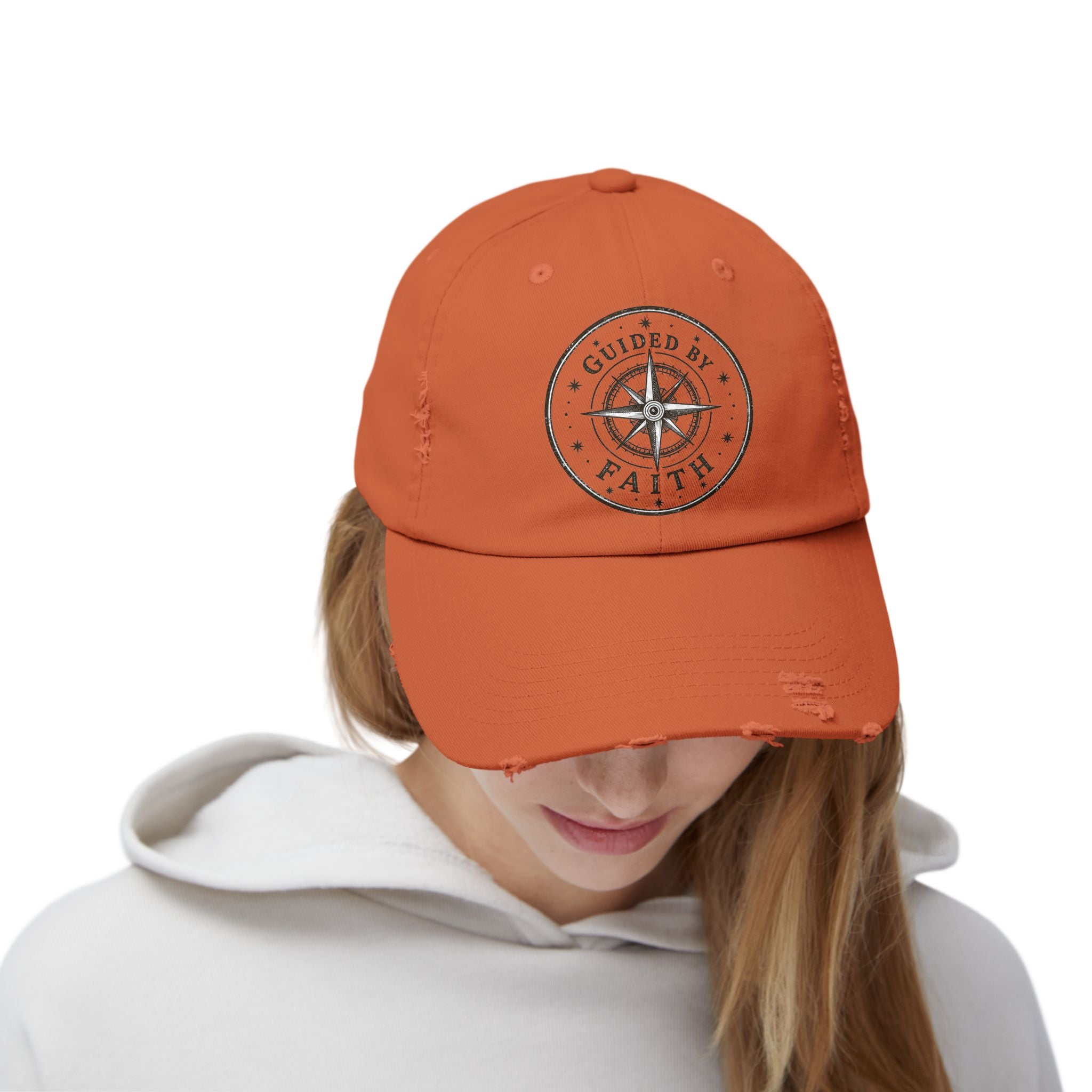 Vintage distressed Christian baseball cap featuring a compass emblem and the phrase “Guided by Faith” on a soft low-profile cotton twill hat.