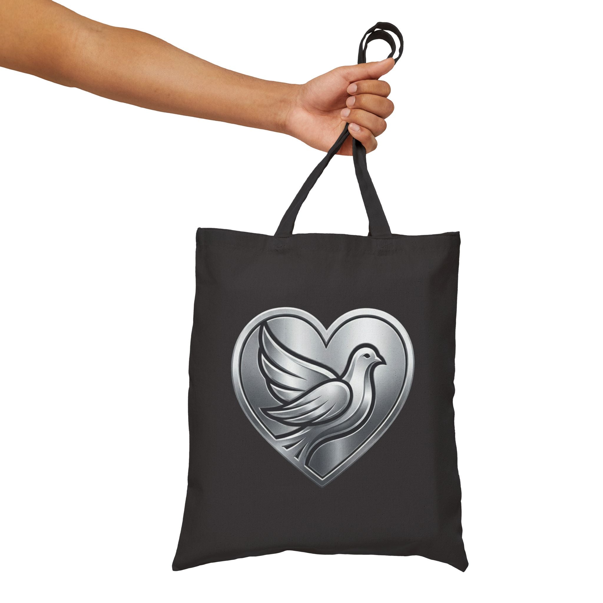 Cotton canvas tote bag featuring a silver dove inside a heart design, symbolizing peace, love, faith, hope, and encouragement in an elegant minimalist style.