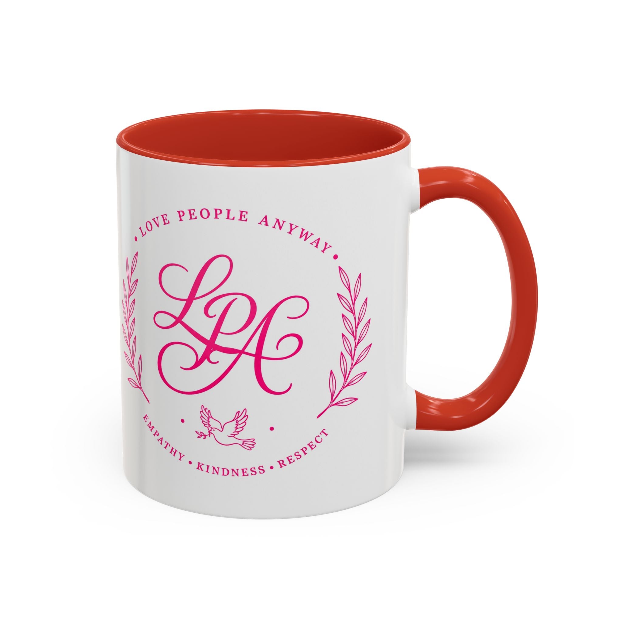 Inspirational ceramic coffee mug featuring soft pink “Love People Anyway” lettering, laurel accents, a dove motif, and contrasting red handle and interior.