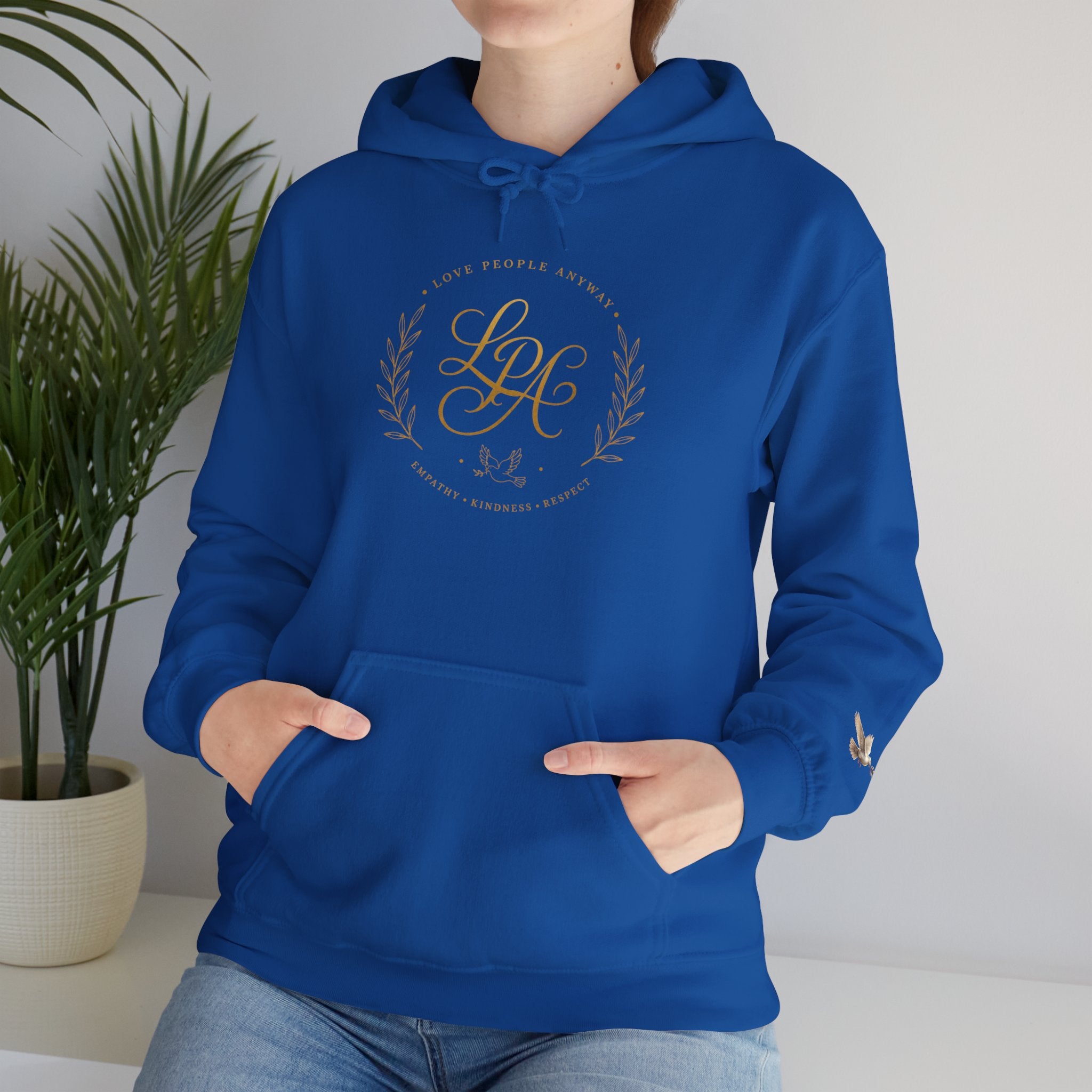 Inspirational Christian hoodie featuring elegant “Love People Anyway” script typography on a soft, cozy hooded sweatshirt designed to encourage kindness and compassion.