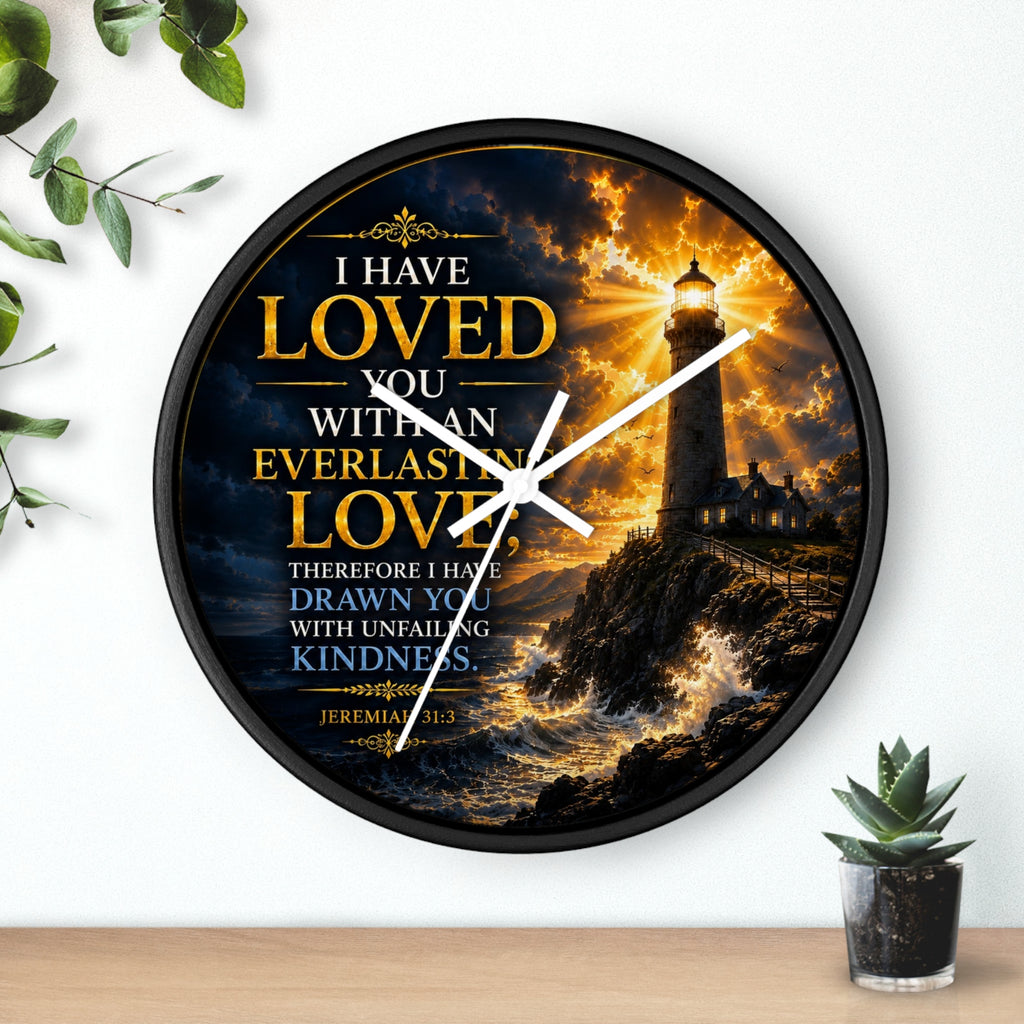 Inspirational Christian wall clock featuring a glowing lighthouse over stormy seas with Jeremiah 31:3 scripture about everlasting love in warm golden tones.