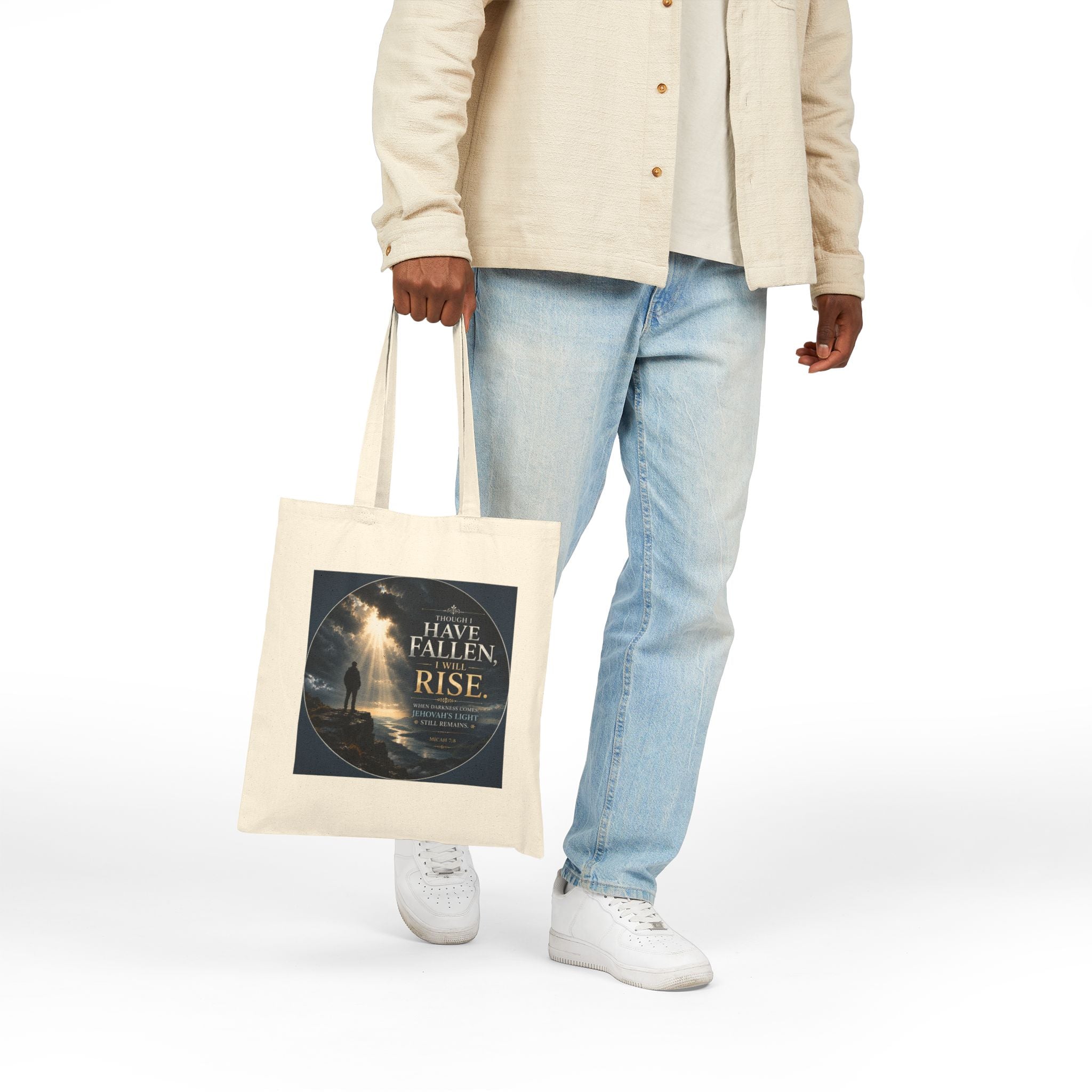 Christian cotton canvas tote bag featuring Micah 7:8 and the message “Though I Have Fallen, I Will Rise,” with dramatic mountain landscape artwork, storm clouds, rays of light, and inspirational faith-based design.