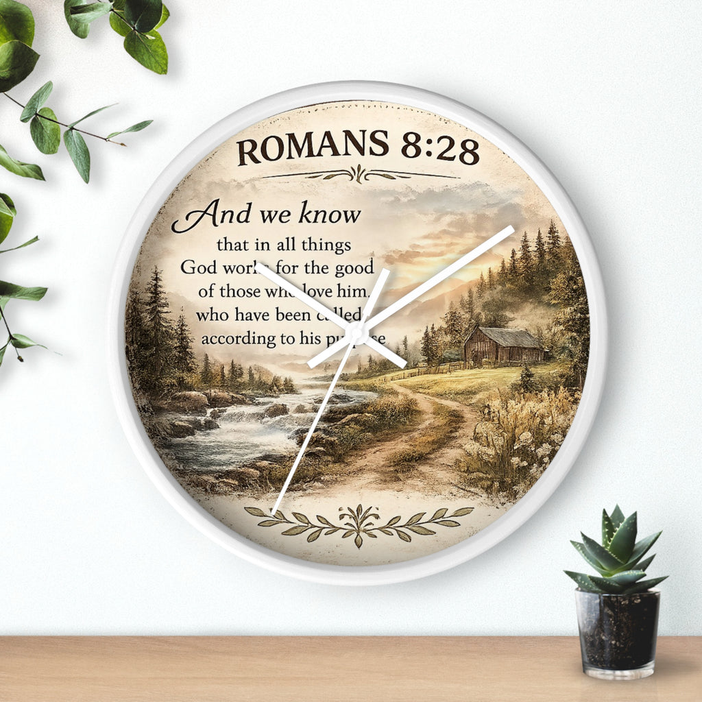 Inspirational Christian wall clock featuring Romans 8:28 scripture with a rustic cabin, flowing creek, and sunset landscape in warm countryside colors.