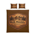 Rustic cotton duvet cover set featuring a leather-style mountain badge with pine trees and the words "Walk Humbly" inspired by Micah 6:8 on warm earth-tone bedding.