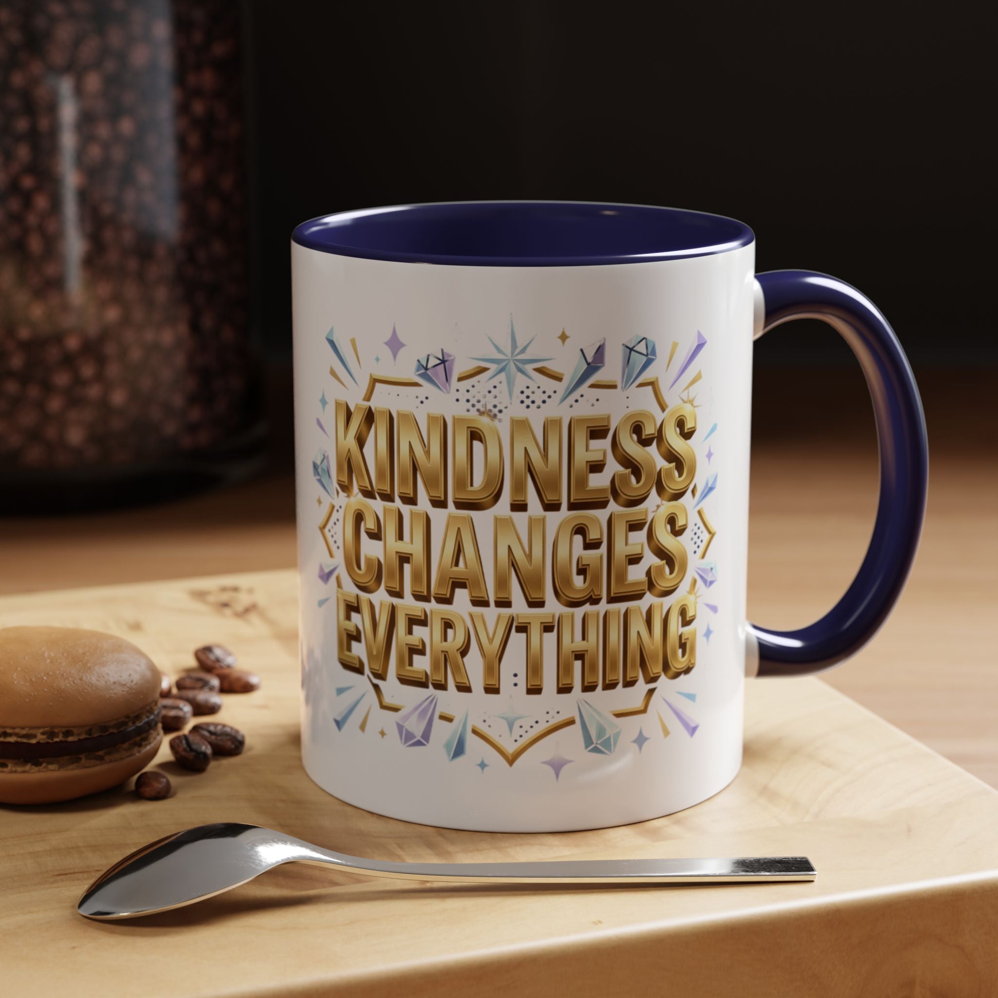 Inspirational ceramic accent coffee mug featuring “Kindness Changes Everything” in elegant gold script with sparkles and colorful accent handle and interior.