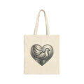 Cotton canvas tote bag featuring a silver dove inside a heart design, symbolizing peace, love, faith, hope, and encouragement in an elegant minimalist style.