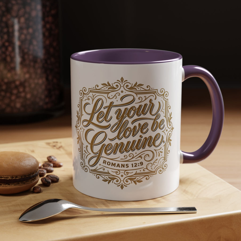 Inspirational ceramic accent coffee mug featuring Romans 12:9 and the message “Let Your Love Be Genuine” in elegant gold script with decorative flourishes and black accent handle and interior.