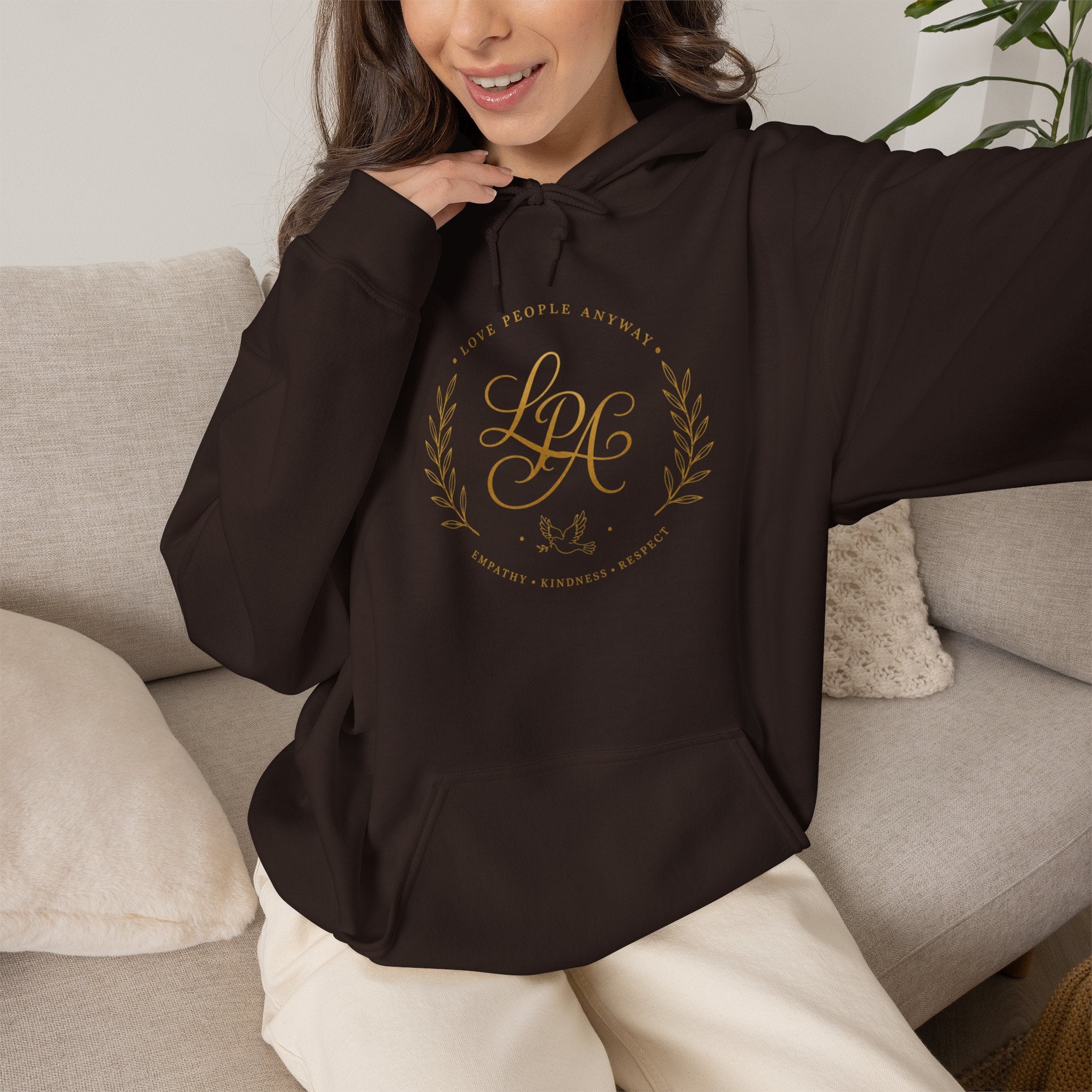Inspirational Christian hoodie featuring elegant “Love People Anyway” script typography on a soft, cozy hooded sweatshirt designed to encourage kindness and compassion.