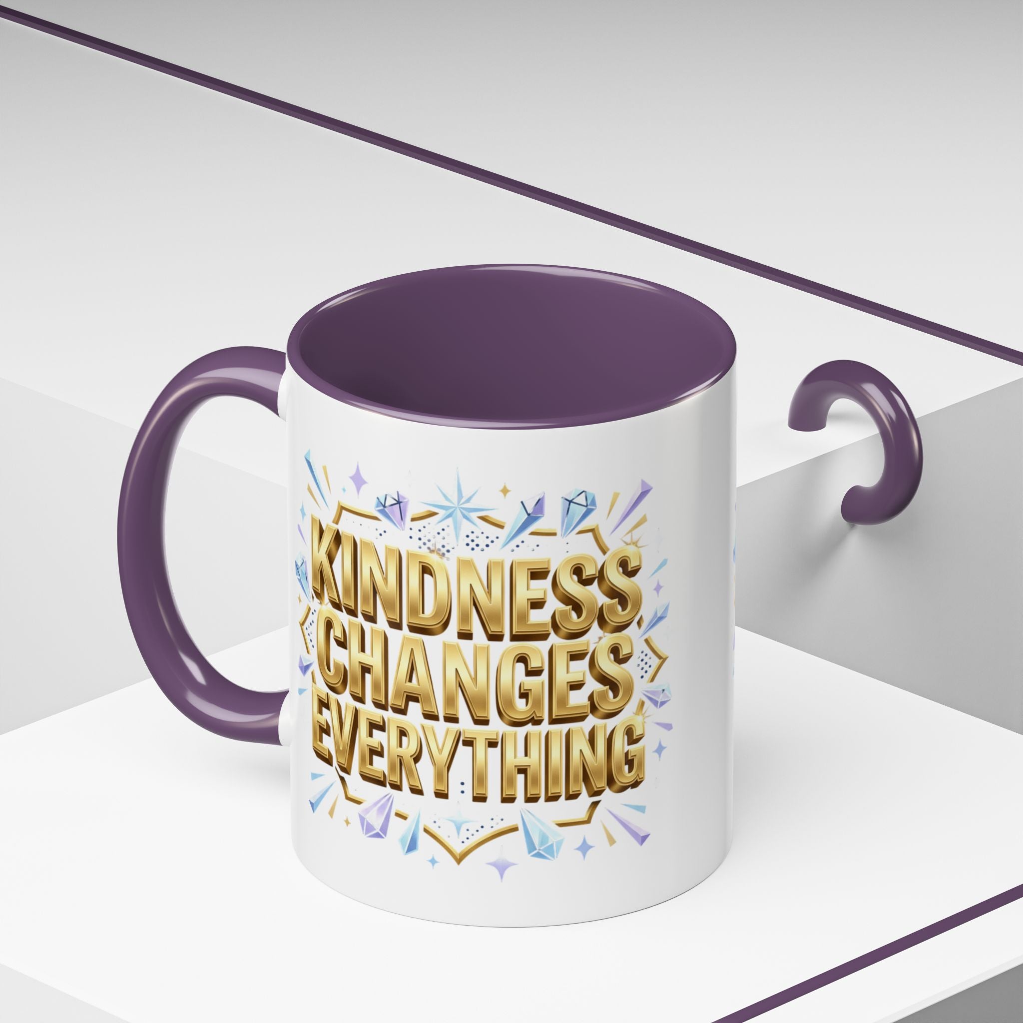 Inspirational ceramic accent coffee mug featuring “Kindness Changes Everything” in elegant gold script with sparkles and colorful accent handle and interior.