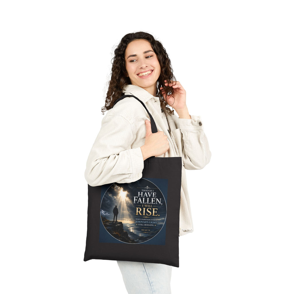 Christian cotton canvas tote bag featuring Micah 7:8 and the message “Though I Have Fallen, I Will Rise,” with dramatic mountain landscape artwork, storm clouds, rays of light, and inspirational faith-based design.