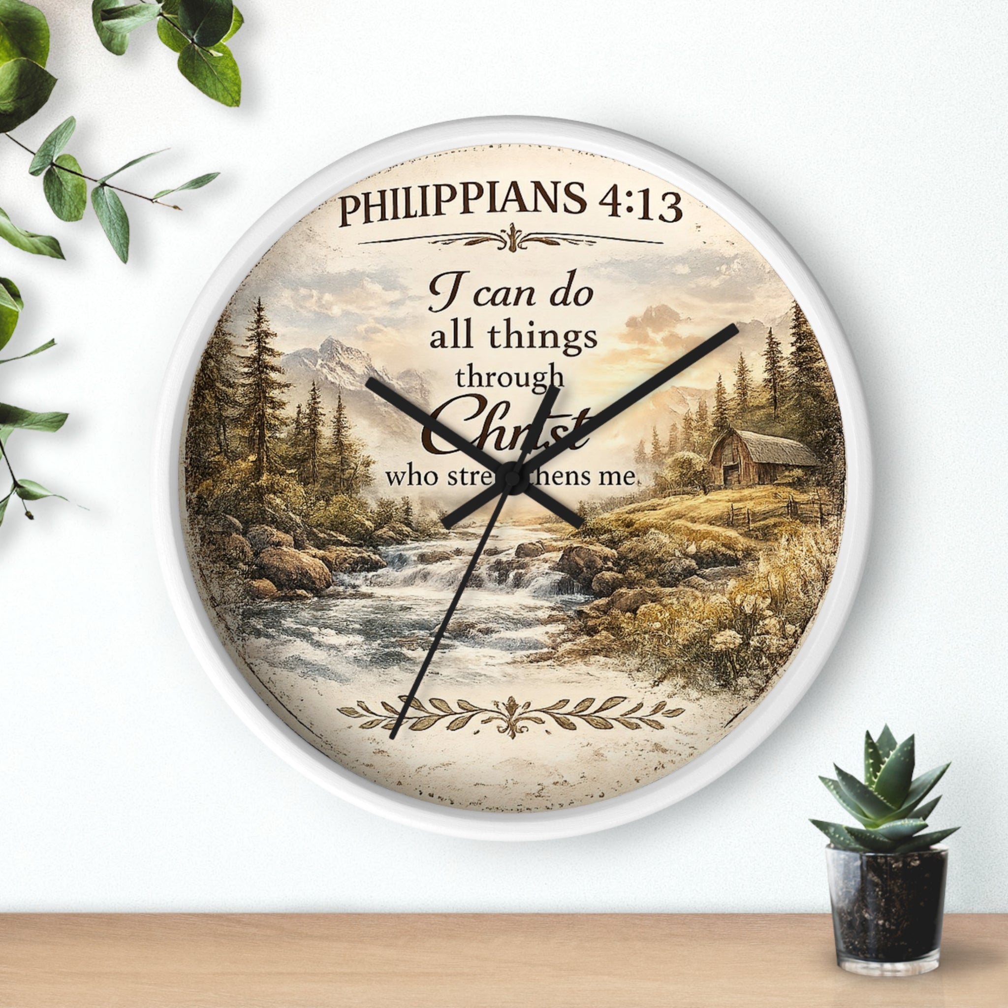 Inspirational Christian wall clock featuring Philippians 4:13 with a rustic cabin, flowing river, pine trees, and peaceful countryside landscape in warm vintage tones.