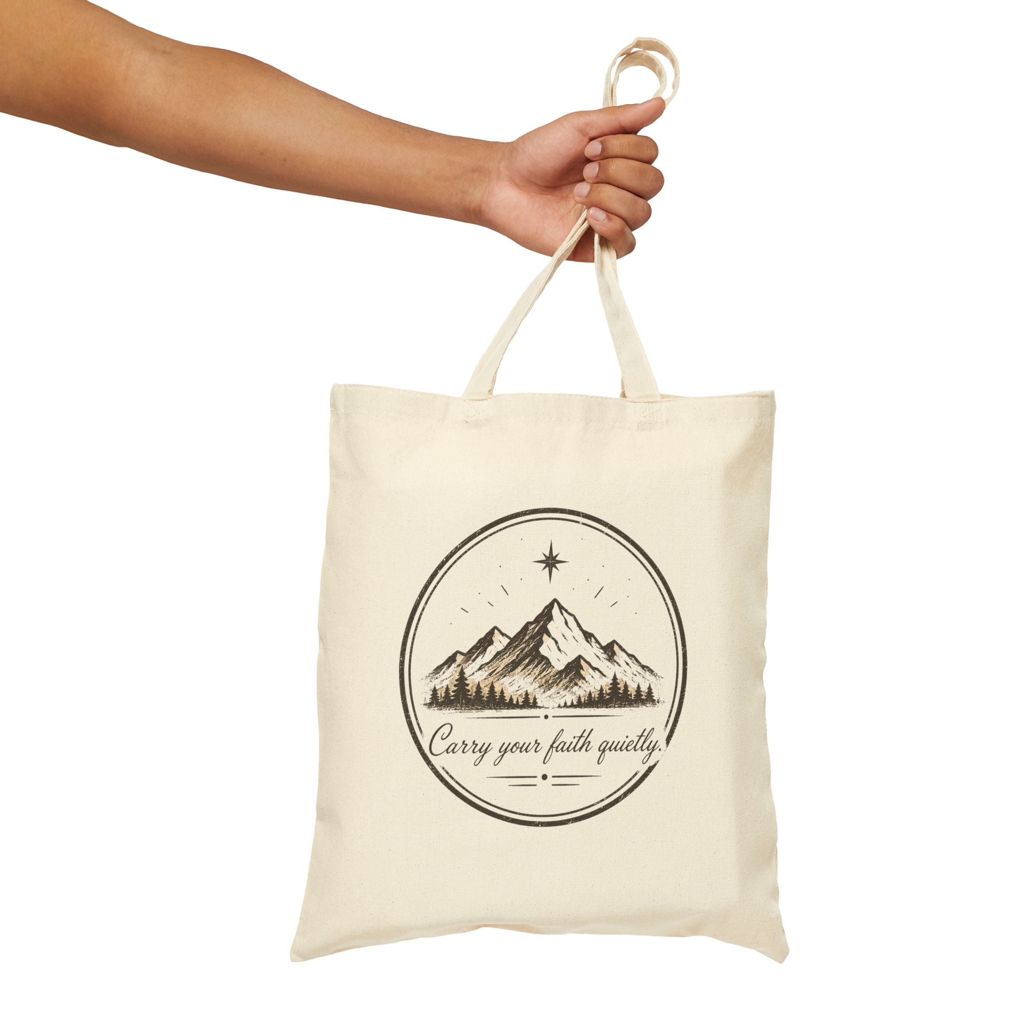 Rustic cotton canvas tote bag featuring mountain peaks, pine trees, a guiding star, and the Faith & Freedom Creations tagline “Carry Your Faith Quietly” in a vintage outdoor-inspired design.