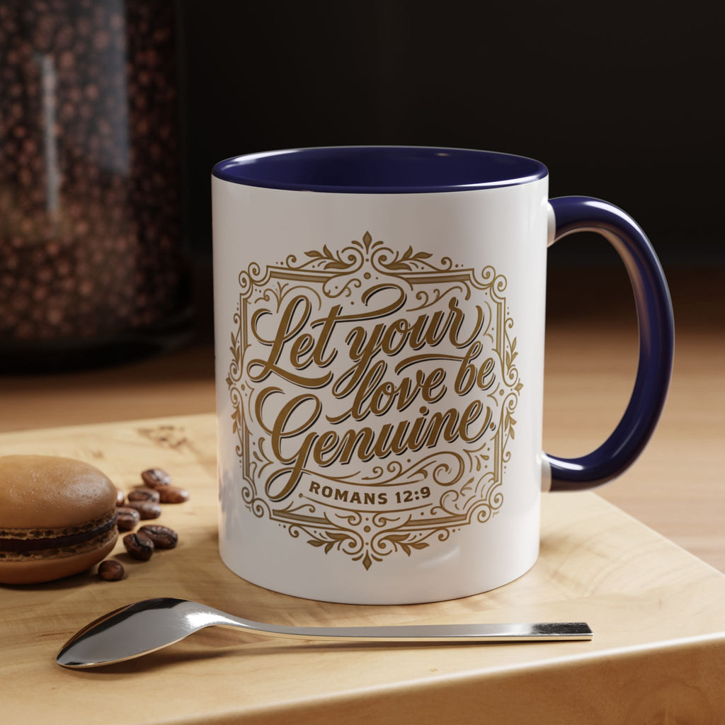 Inspirational ceramic accent coffee mug featuring Romans 12:9 and the message “Let Your Love Be Genuine” in elegant gold script with decorative flourishes and black accent handle and interior.