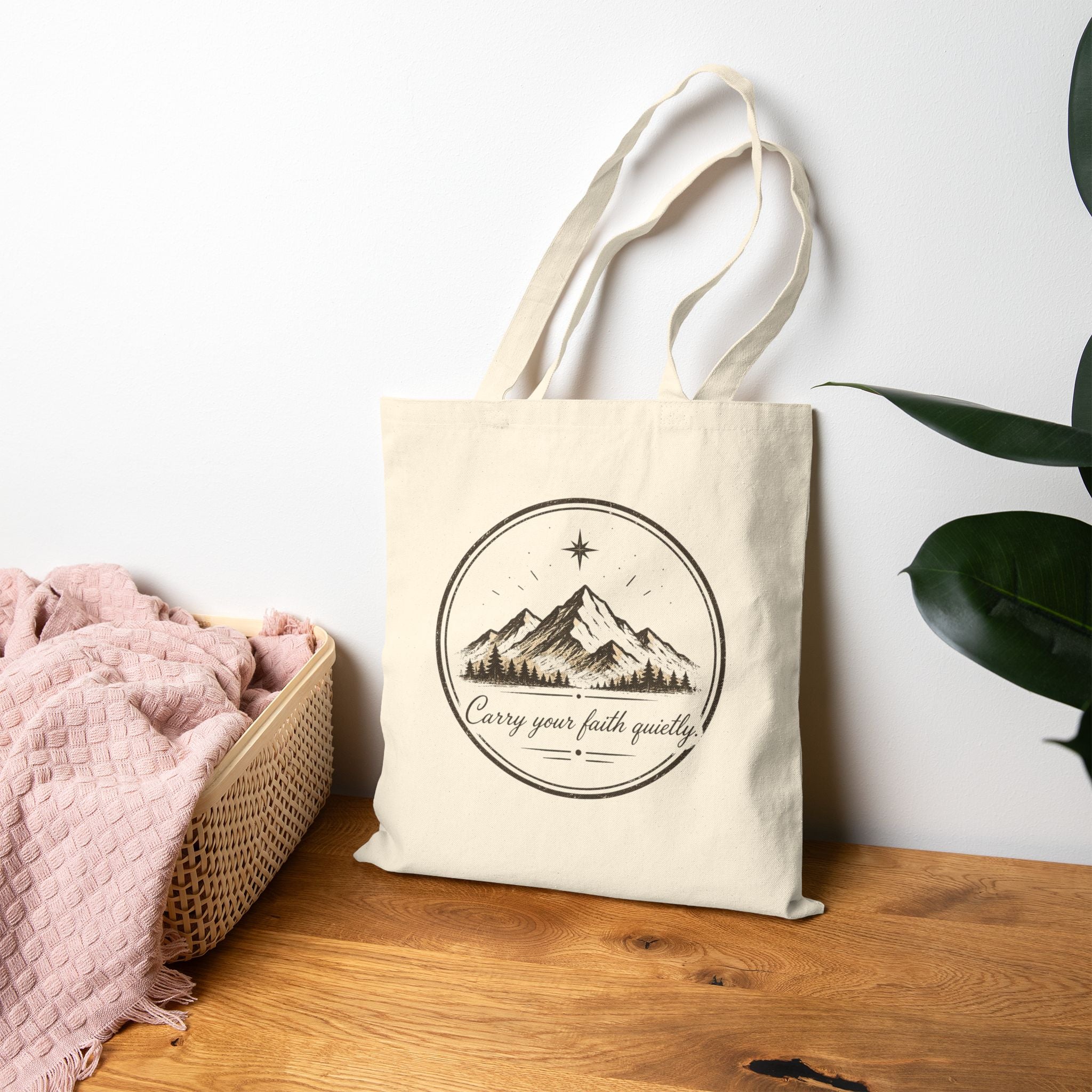 Rustic cotton canvas tote bag featuring mountain peaks, pine trees, a guiding star, and the Faith & Freedom Creations tagline “Carry Your Faith Quietly” in a vintage outdoor-inspired design.