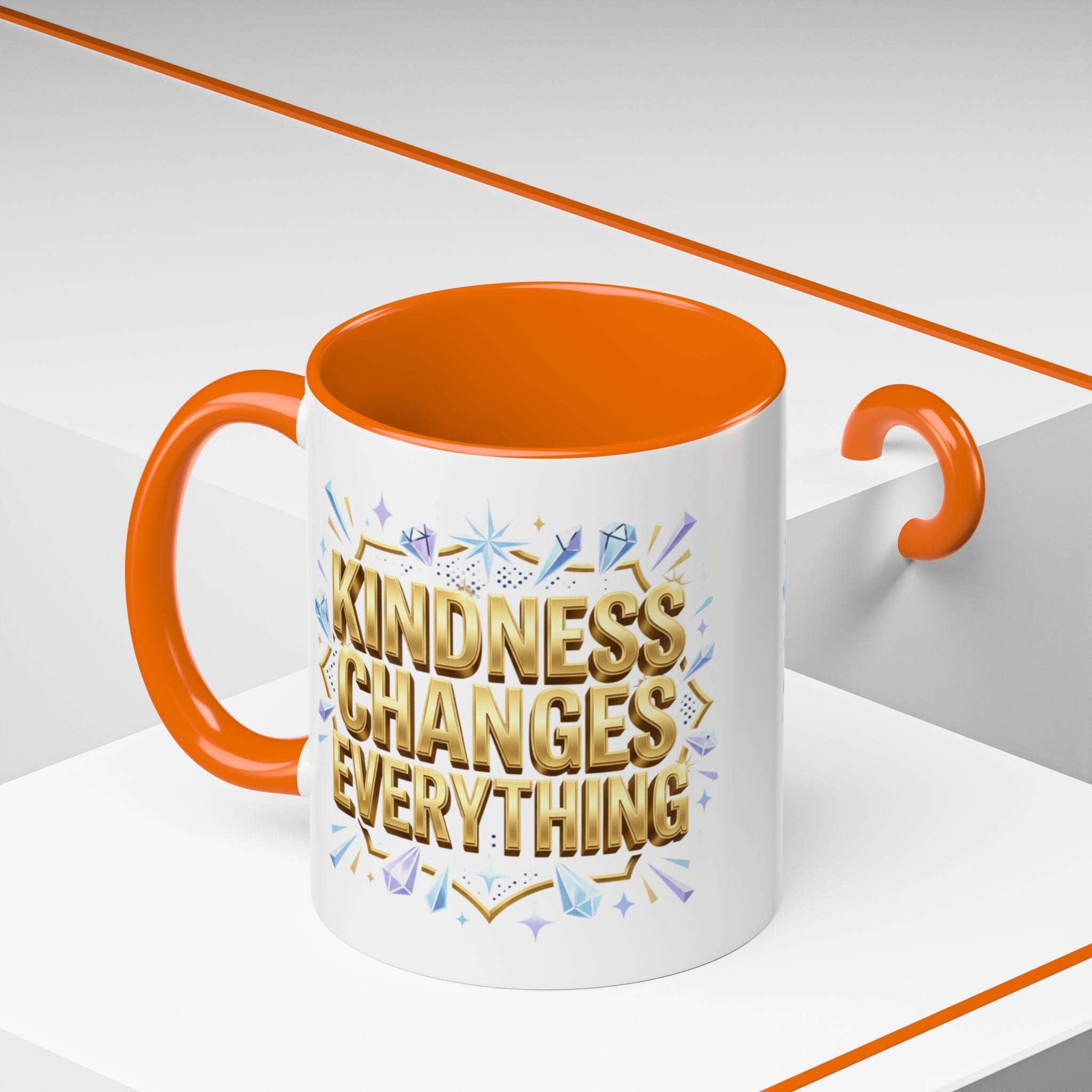 Inspirational ceramic accent coffee mug featuring “Kindness Changes Everything” in elegant gold script with sparkles and colorful accent handle and interior.