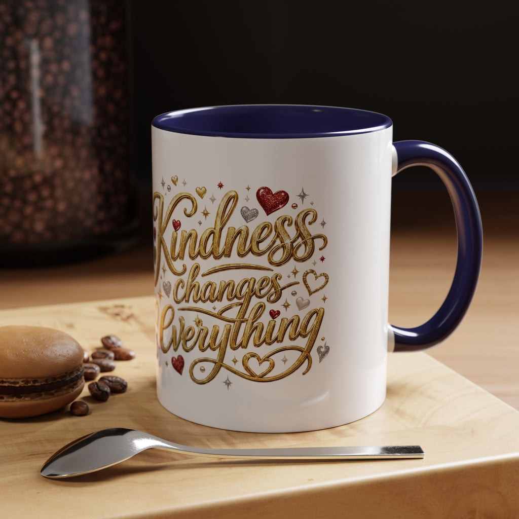 Inspirational ceramic coffee mug featuring the hand-lettered message “Kindness Changes Everything” with gold flourishes, hearts, and colorful accent handle and interior.