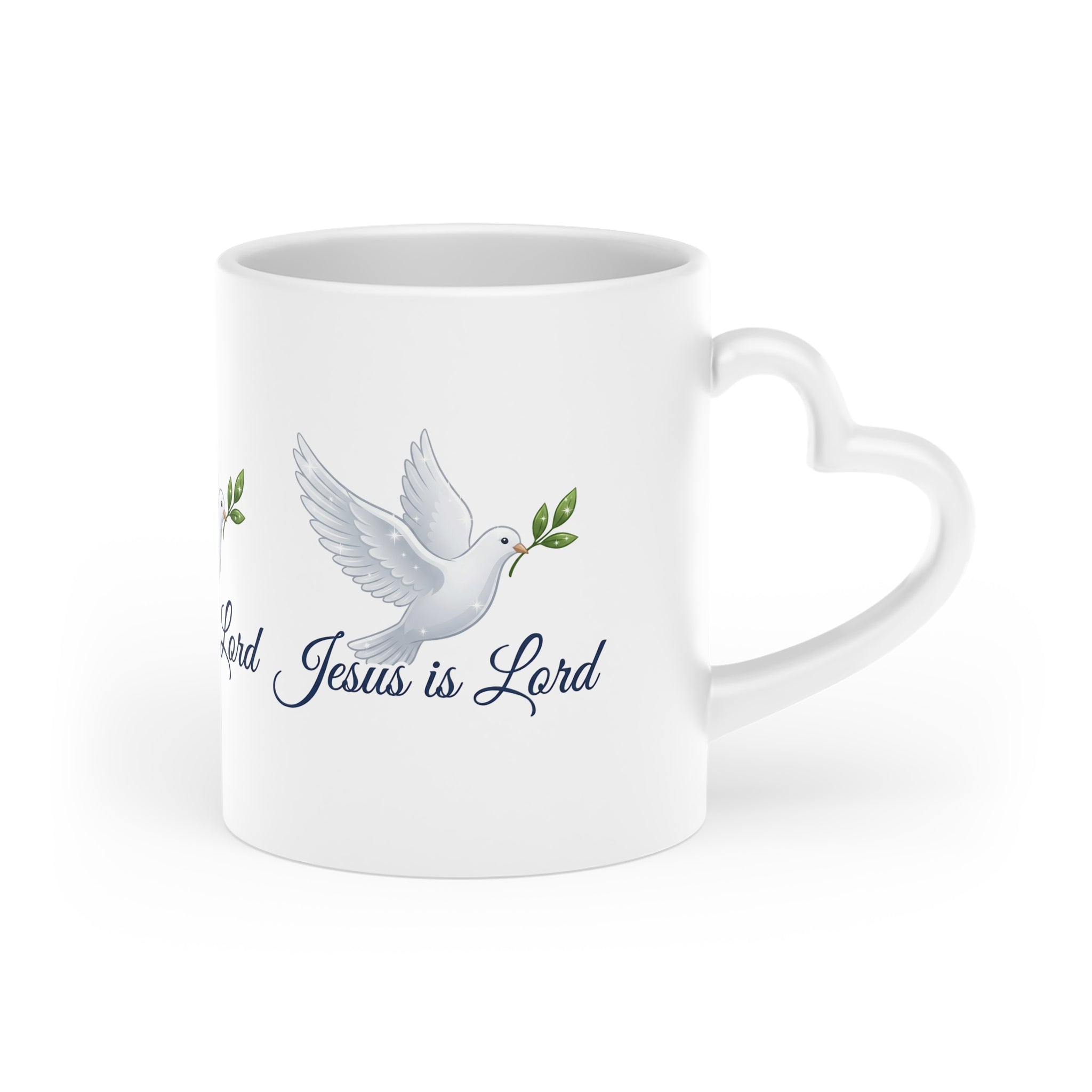 White ceramic heart-shaped handle mug featuring a white dove carrying an olive branch with the words "Jesus Is Lord" in elegant script on a glossy finish.