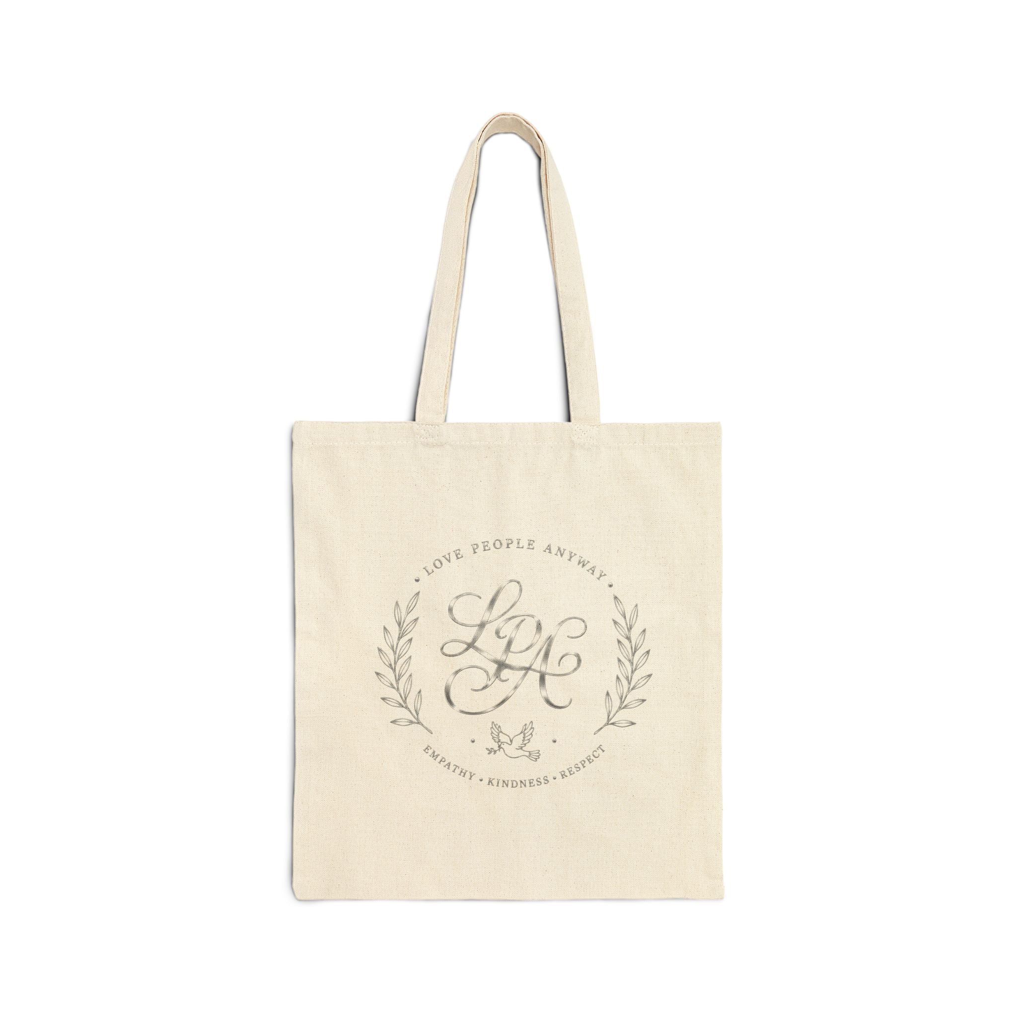 Elegant cotton canvas tote bag featuring a silver monogram crest, laurel branches, dove with olive branch, and the message “Love People Anyway” with empathy, kindness, and respect accents.