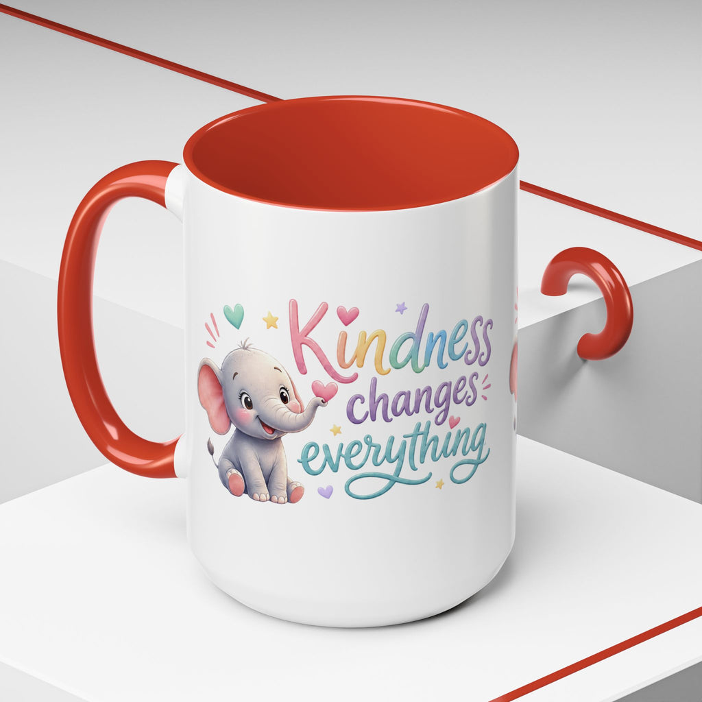 Cute ceramic coffee mug featuring a pastel baby elephant and the uplifting message “Kindness Changes Everything” with colorful accent handle and interior.