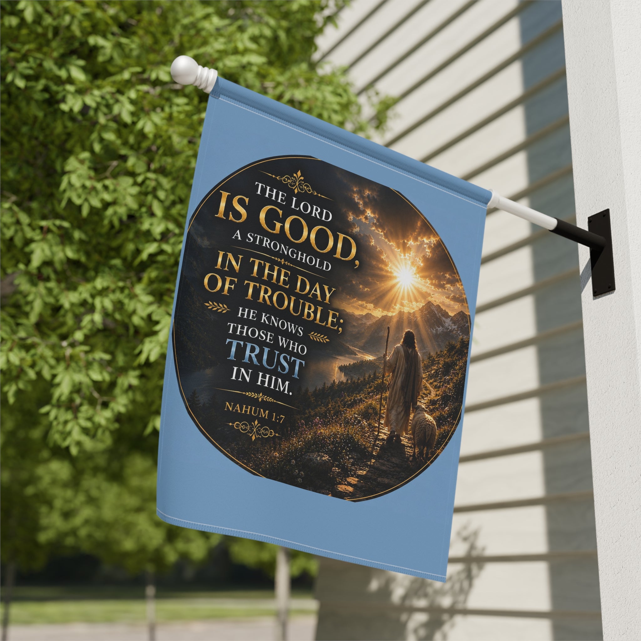 Inspirational Christian garden flag featuring a sunrise pathway scene with a lone figure walking toward golden light and “The Lord Is Good” scripture artwork.