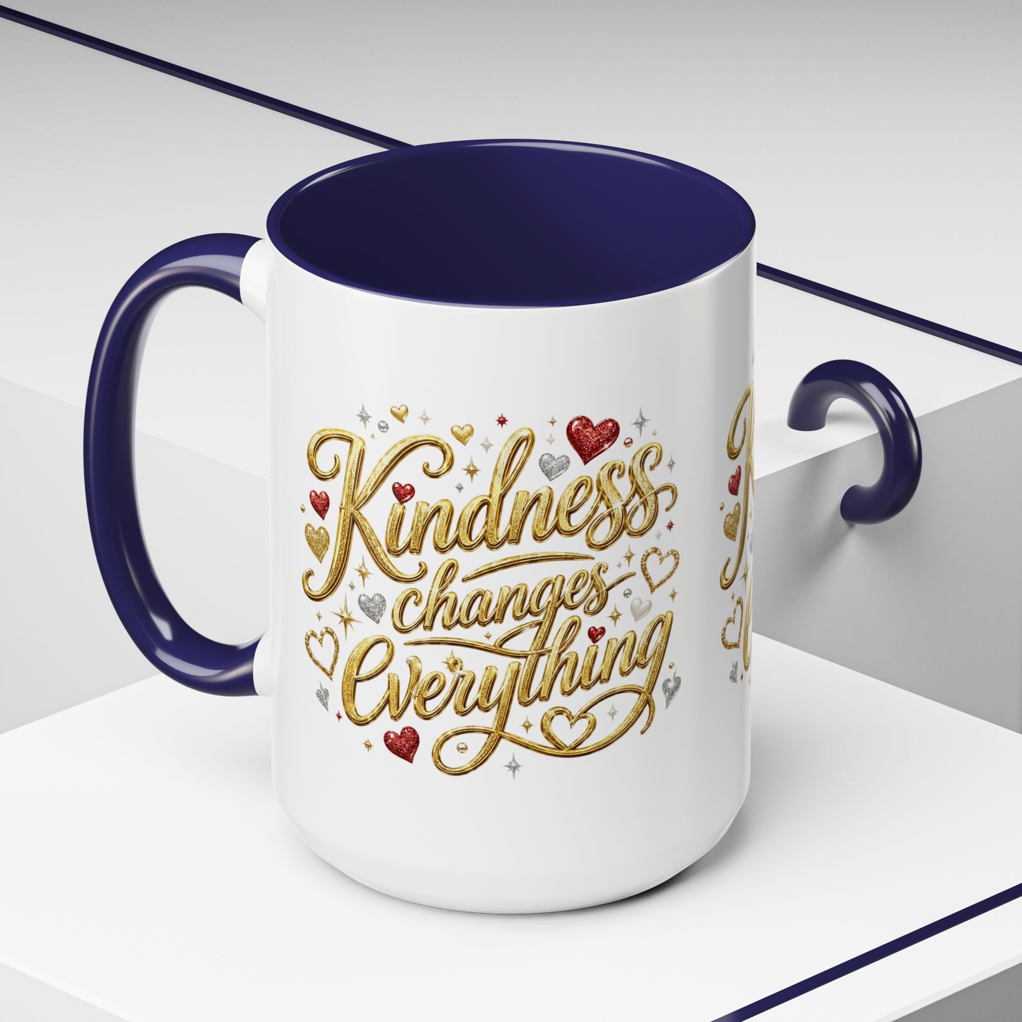 Inspirational ceramic coffee mug featuring the hand-lettered message “Kindness Changes Everything” with gold flourishes, hearts, and colorful accent handle and interior.