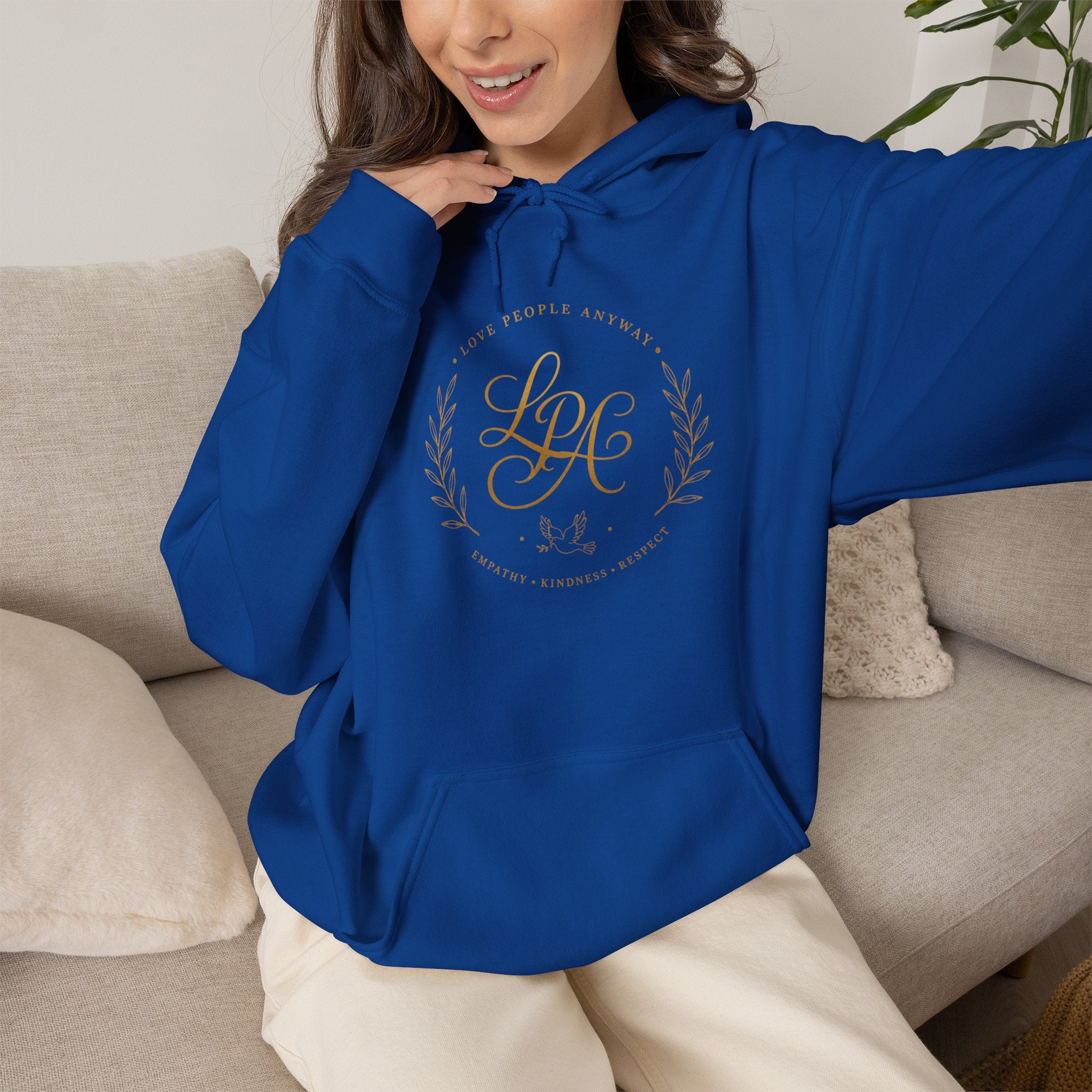 Inspirational Christian hoodie featuring elegant “Love People Anyway” script typography on a soft, cozy hooded sweatshirt designed to encourage kindness and compassion.