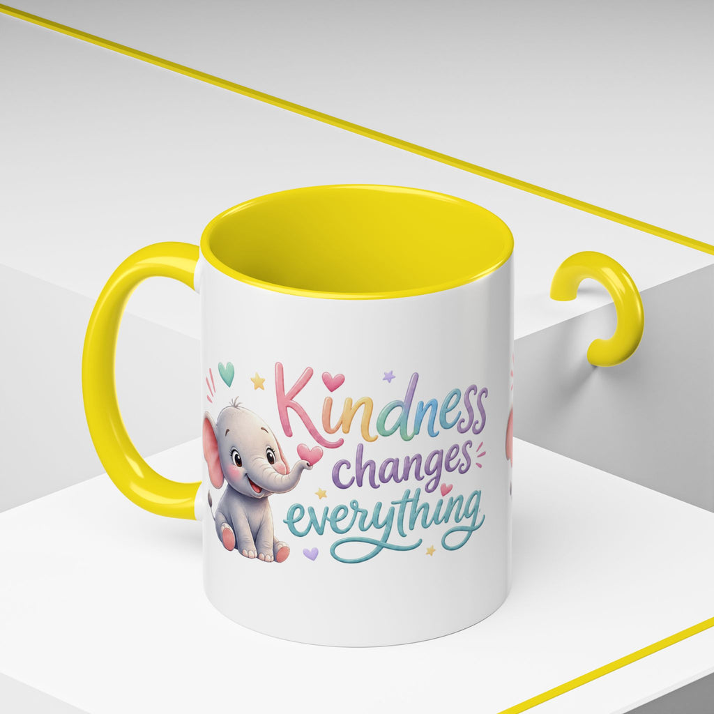 Cute ceramic coffee mug featuring a pastel baby elephant and the uplifting message “Kindness Changes Everything” with colorful accent handle and interior.
