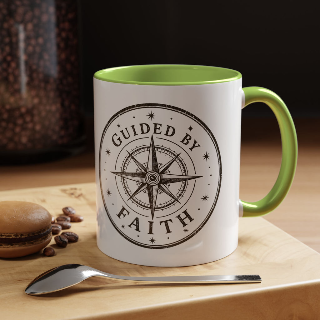 Inspirational ceramic accent coffee mug featuring a compass design and “Guided by Faith” message with colorful handle and interior accents on a glossy white mug.