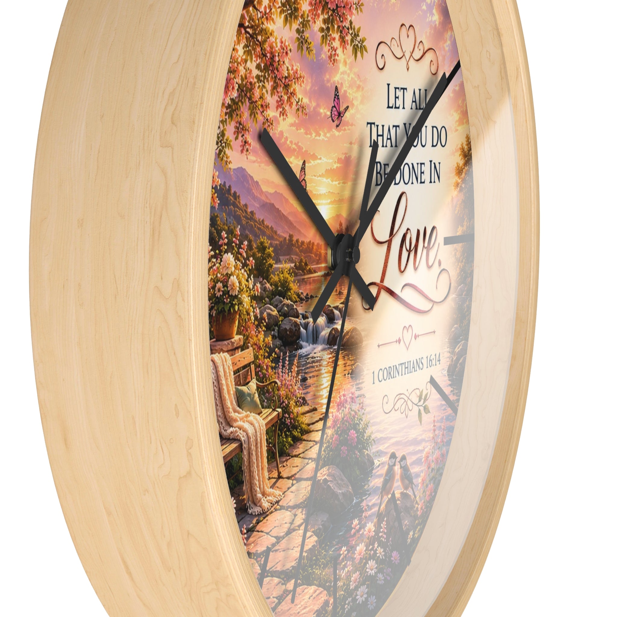 Inspirational Christian wall clock featuring a flower-lined lakeside sunrise scene with 1 Corinthians 16:14 scripture about doing all things in love.