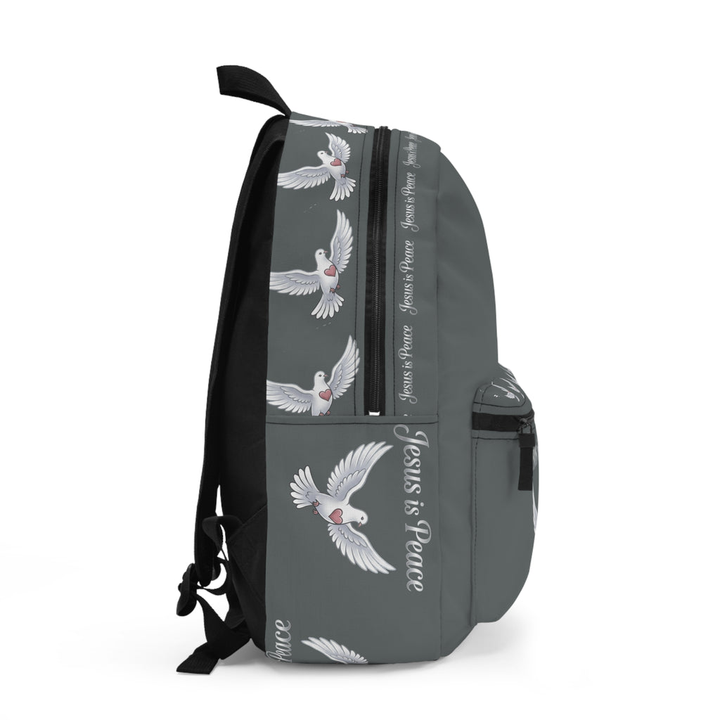 Gray Christian backpack featuring a white dove carrying a heart beneath the words "Jesus Is Peace," with multiple zippered compartments and padded shoulder straps.